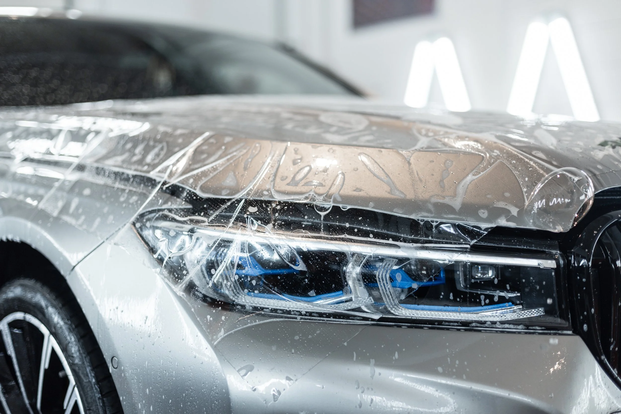 Paint protection film PPF installation on a car bumper in Boston MA