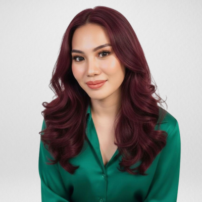 A woman with dark hair, wearing a black turtleneck, looking directly at the camera with a neutral expression.