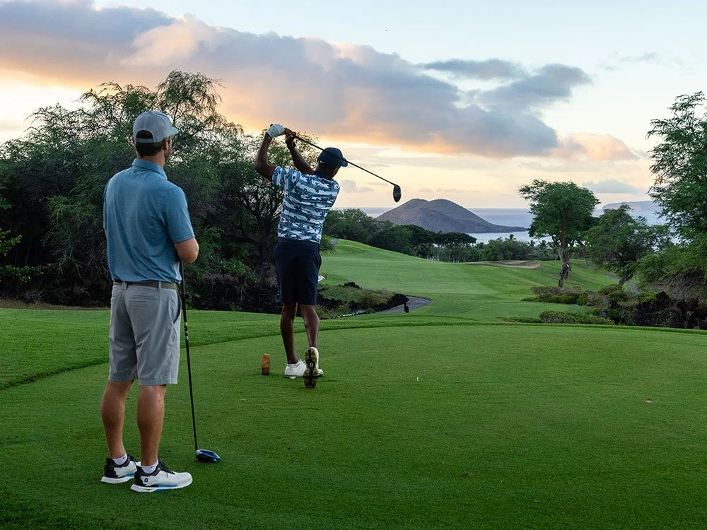 Two men playing golf at Wailea Golf Club.