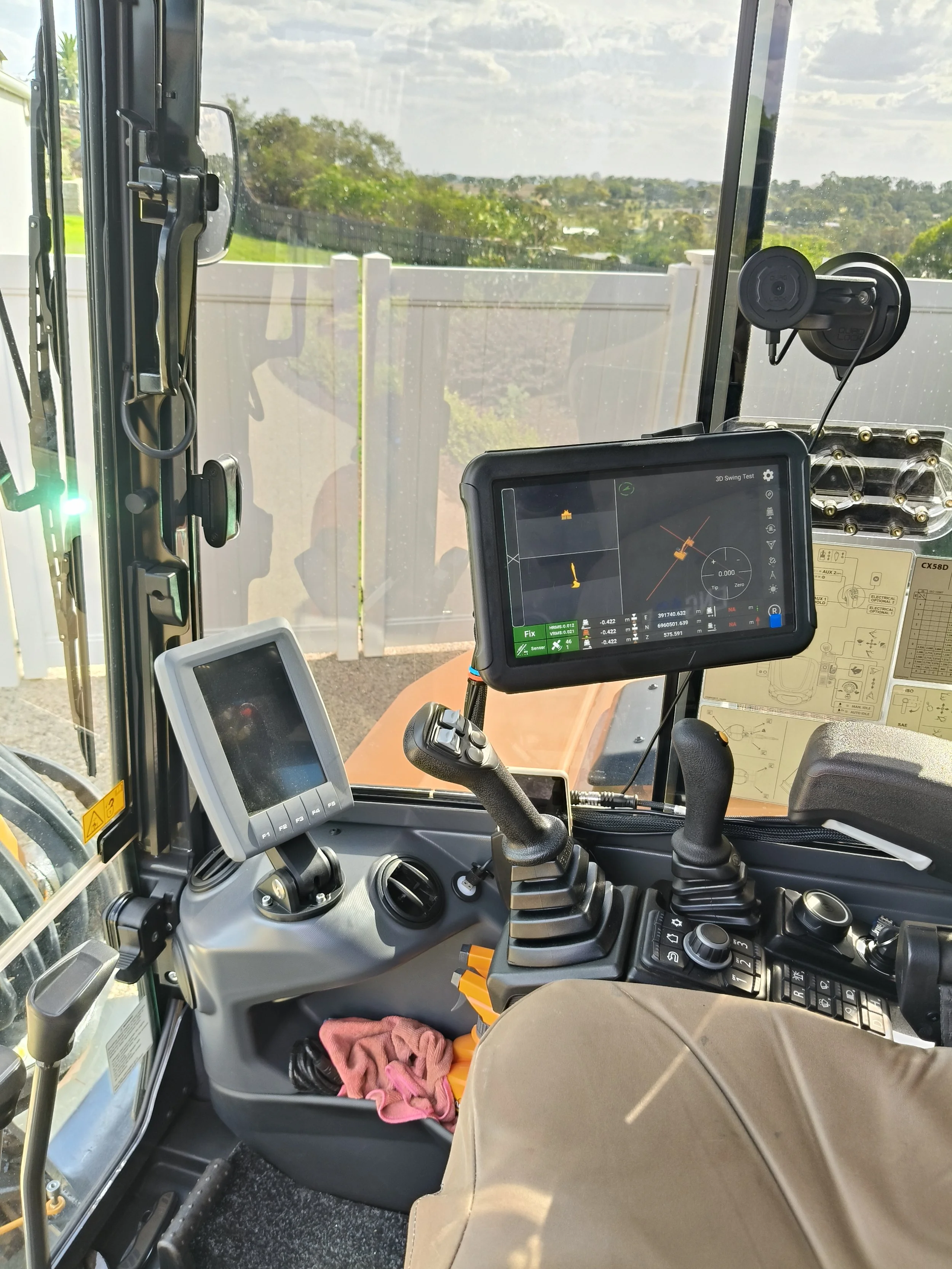Guidemate X-Track excavator control system installed inside a compact excavator cab