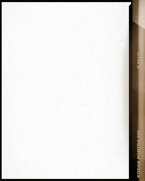 Night sky with stars and part of a building or wall on the right side.