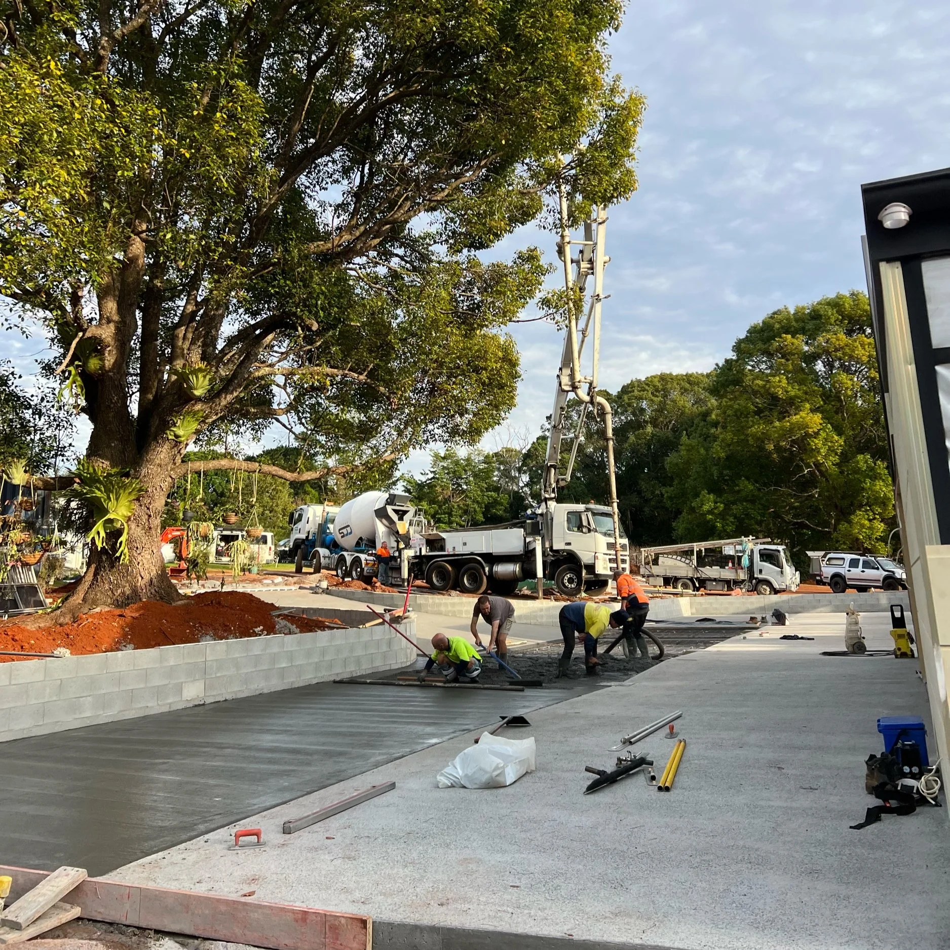 Concreters pouring and levelling for a concrete commercial sidewalk and concrete patio in Burleigh Gold Coast QLD, Australia.