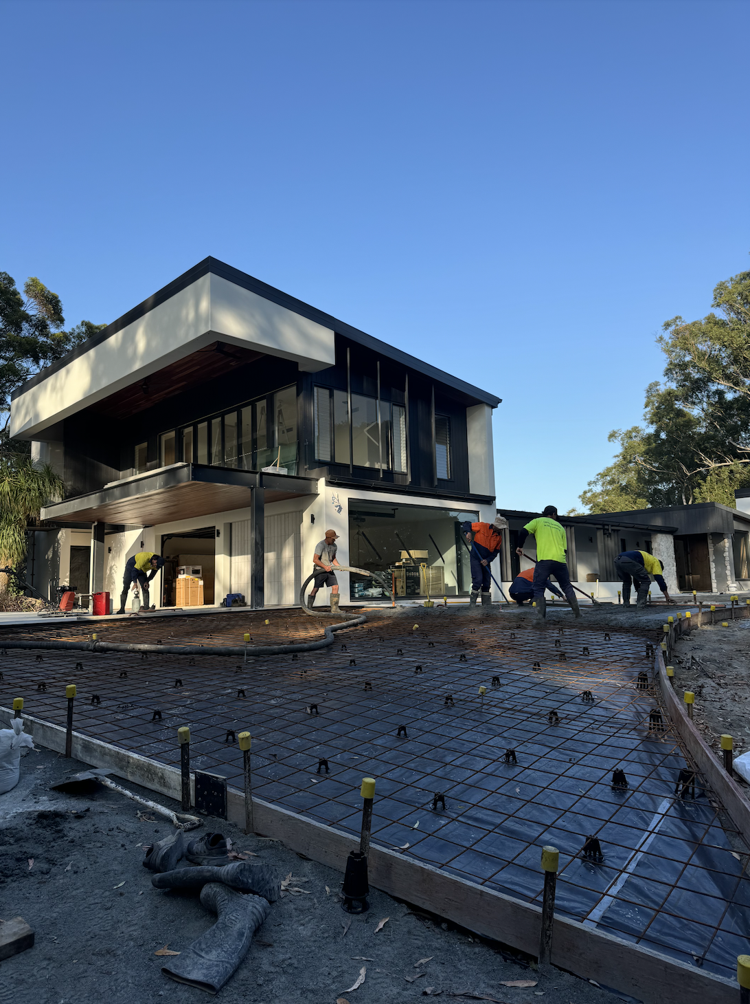 Concreters are pouring a concrete driveway in Palm Beach, Gold Coast, Queensland.