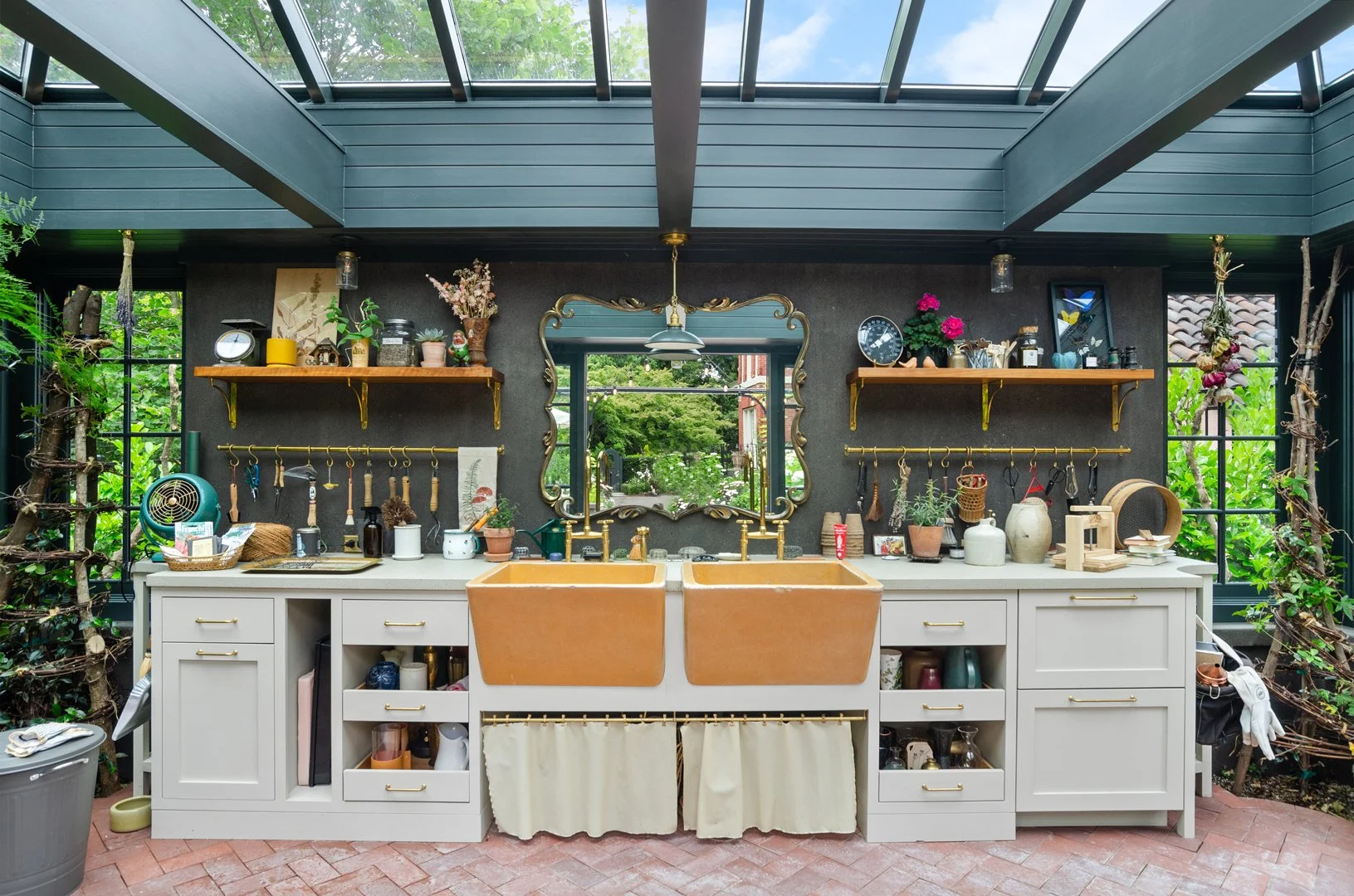 The original laundry sinks from the house's basement have become the focal point of the greenhouse.