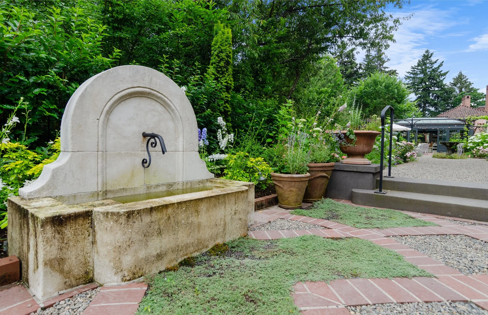 The limestone fountain, imported from France, is a favorite stopping place for the neighborhood birds.