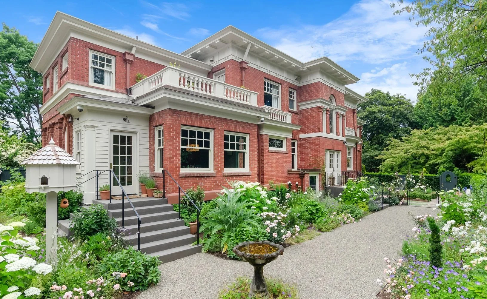 The back facade is the house is much more varied and playful than the front, and we've bordered it with a deep bed full of flowering shrubs and perennials.
