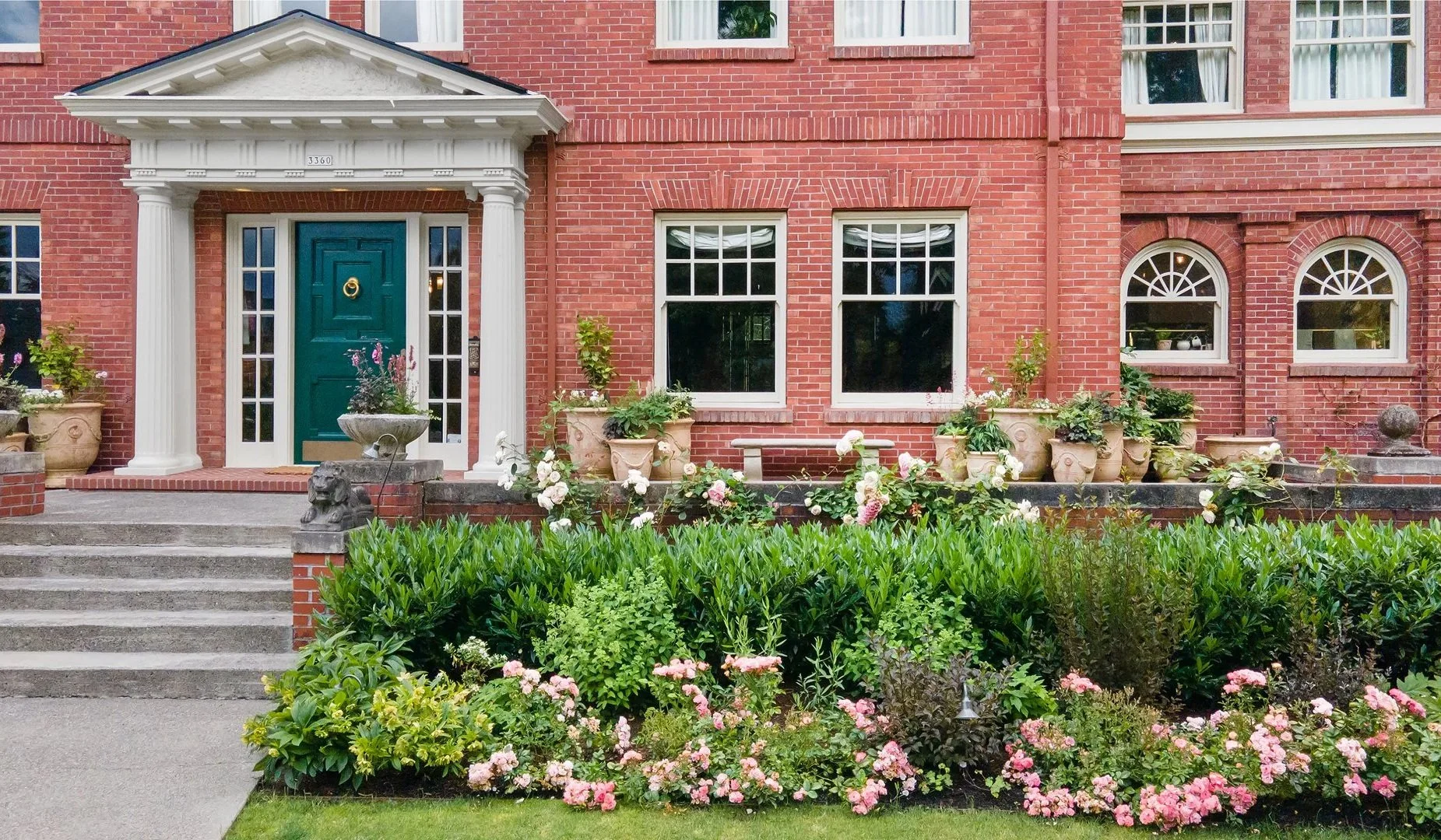 French Anduze planters seem to be proliferating of their own accord on the large front porch.