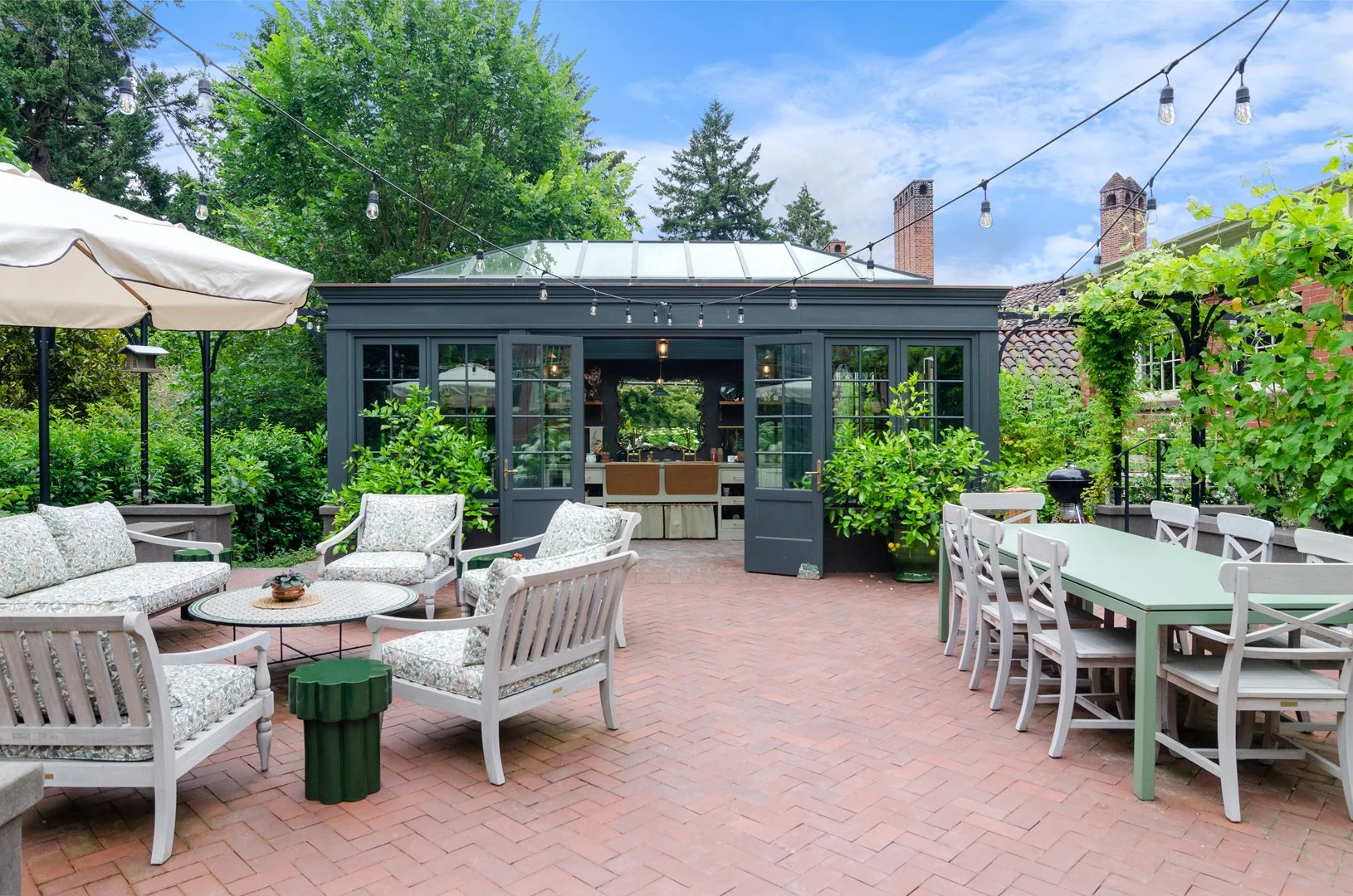 The custom greenhouse, designed in collaboration with Mira Eng-Goetz of Jessica Helgerson Interior Design, is a year-round haven in the garden.