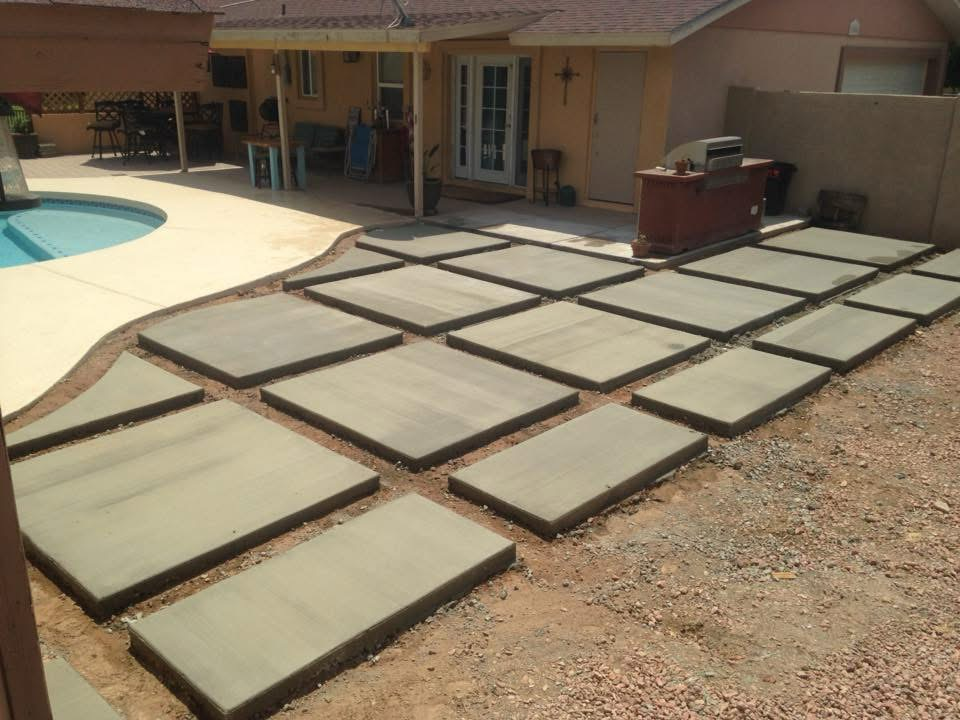 Backyard patio with concrete pavers and poolside area.