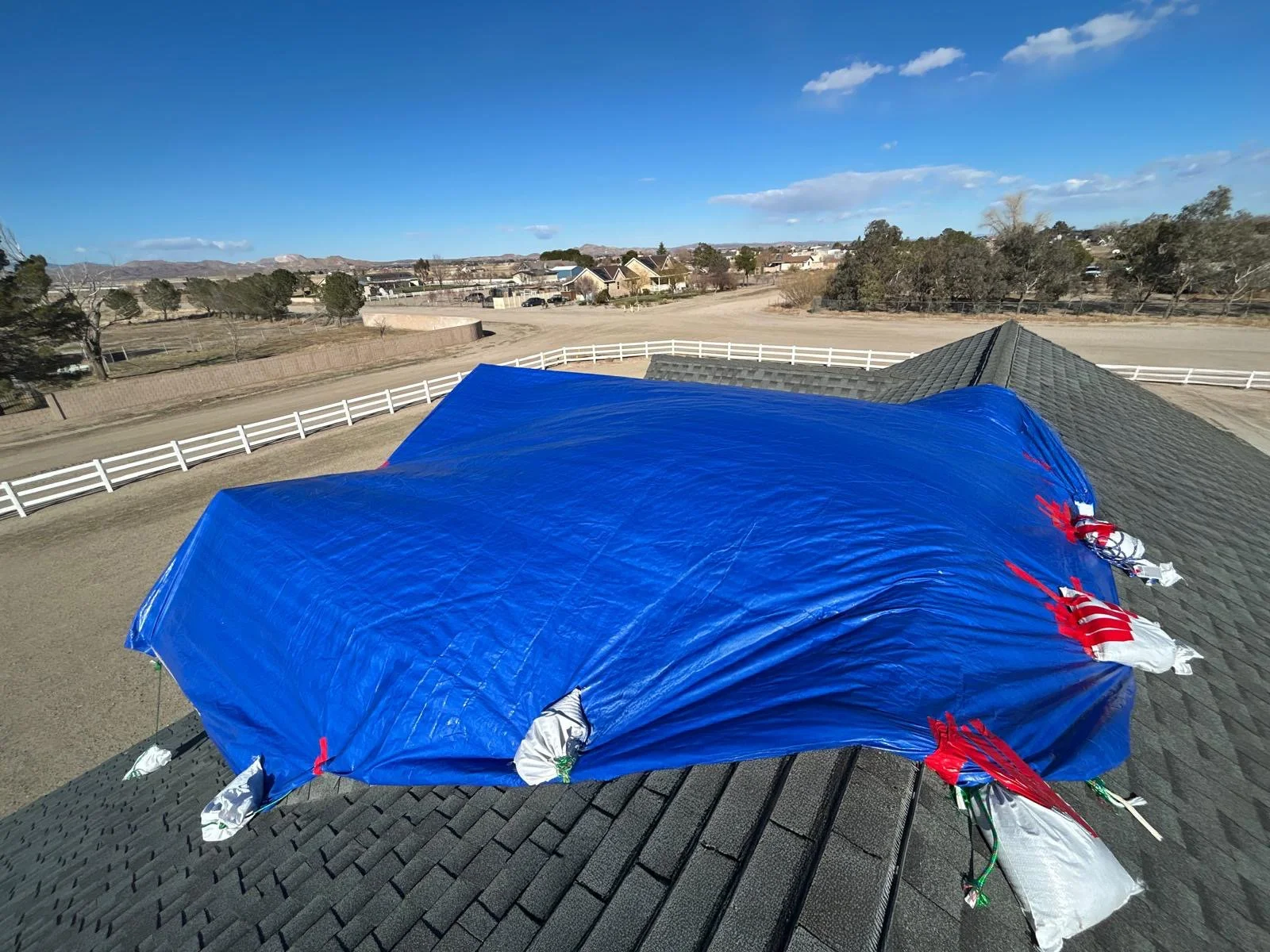 Blue tarp covering the roof of a house