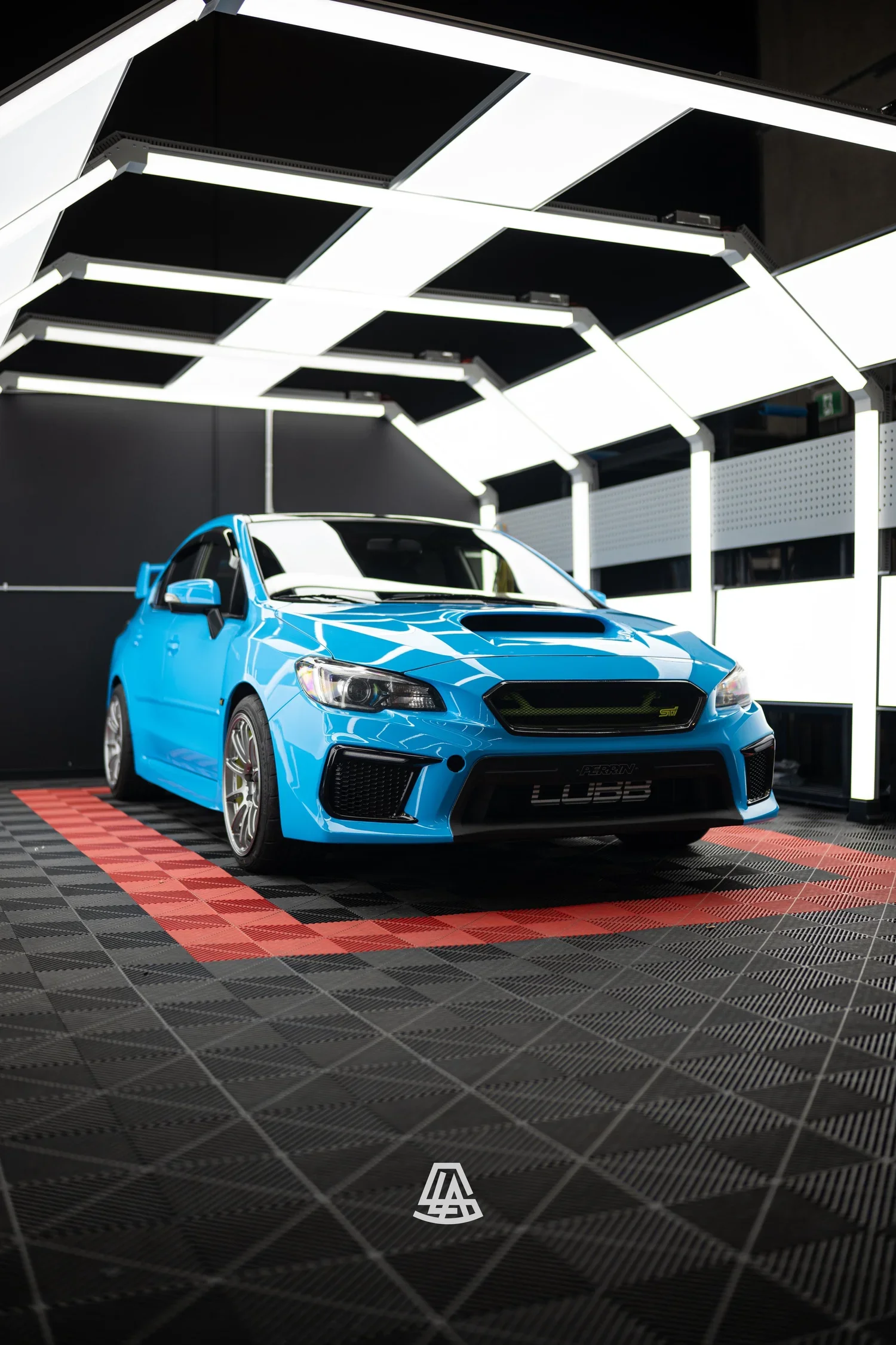 Subaru WRX in a bright blue vinyl wrap at the Luminous Auto Salon shop in Calgary