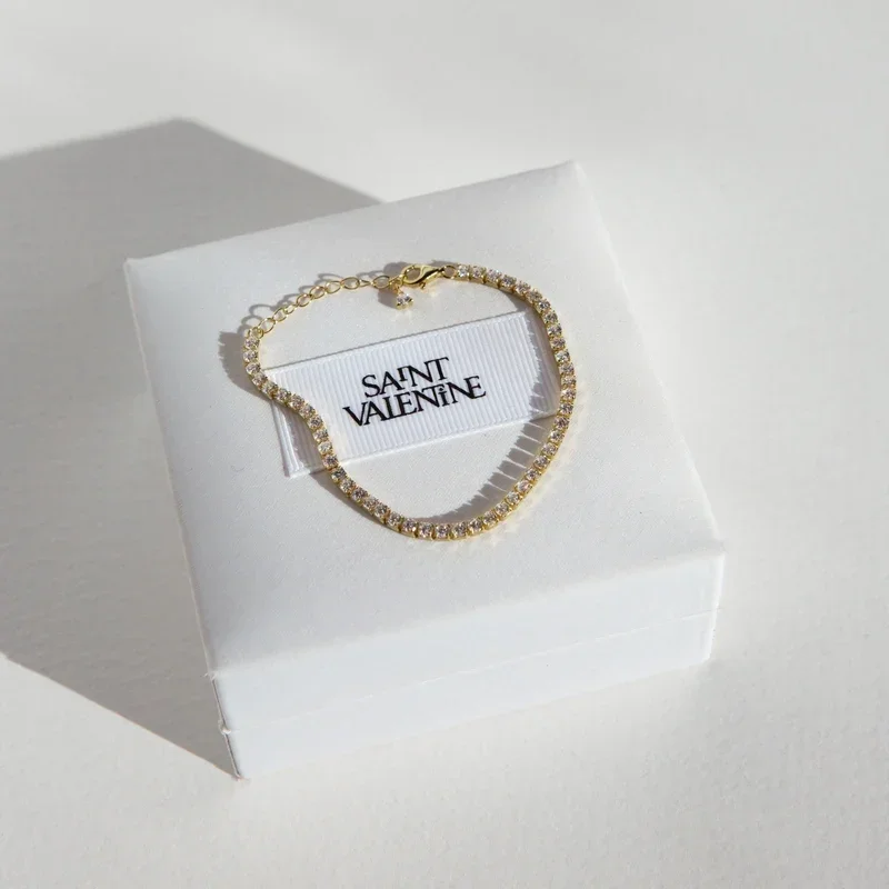 UpdatedAspenTennisBraceletFlatlayGoldSquare.webp