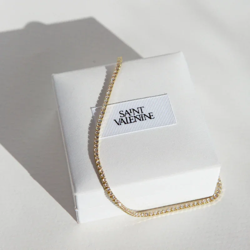 UpdatedAspenTennisNecklaceFlatlayGoldSquare.webp