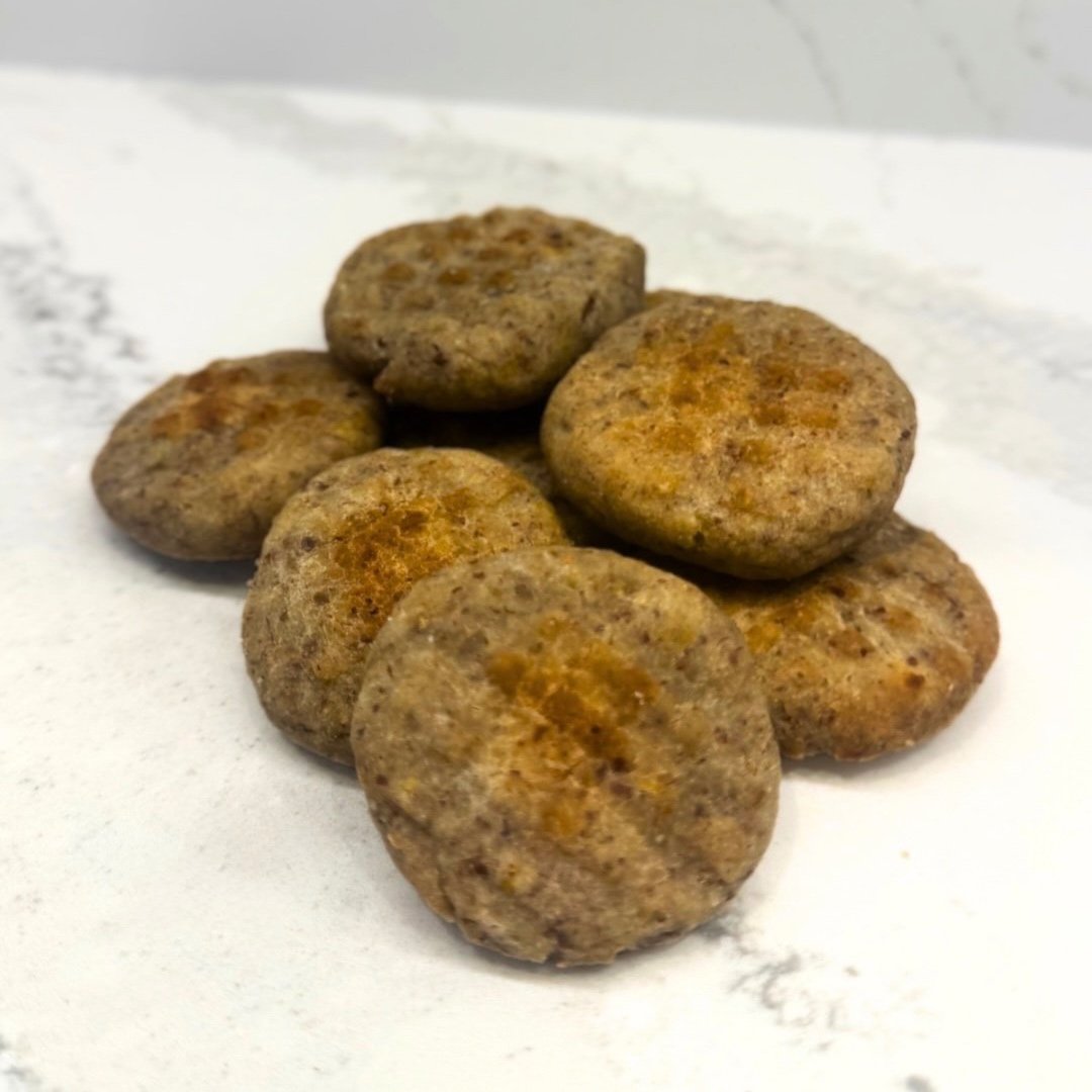 Flaxseed Whole Grain Recharge Biscuits made with organic rice flour, flaxseed, coconut oil, egg, and banana, offering a healthy, energizing treat for dogs.
