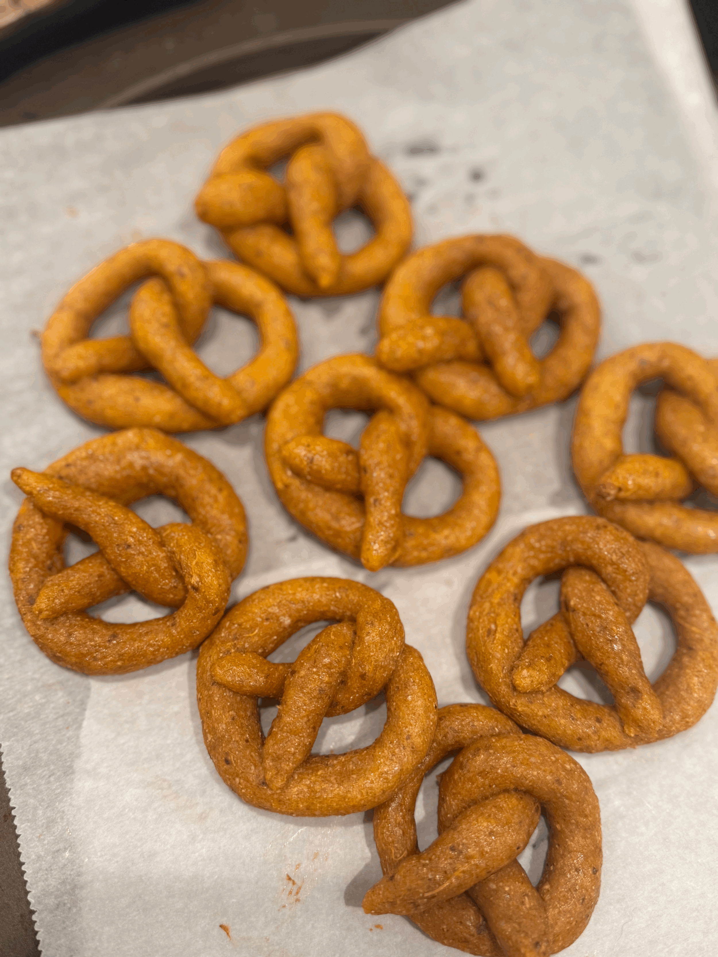 Homemade dog pretzels from Ottawa, made with fresh sweet potato, organic whole grain flour, flaxseed meal, and free-range egg, shaped into golden-brown, crunchy pretzel twists.