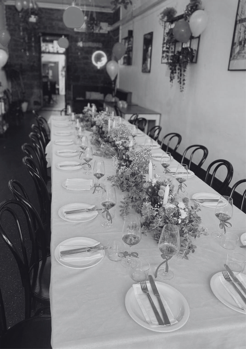 A long table set with candles and flowers for a celebration at Añada