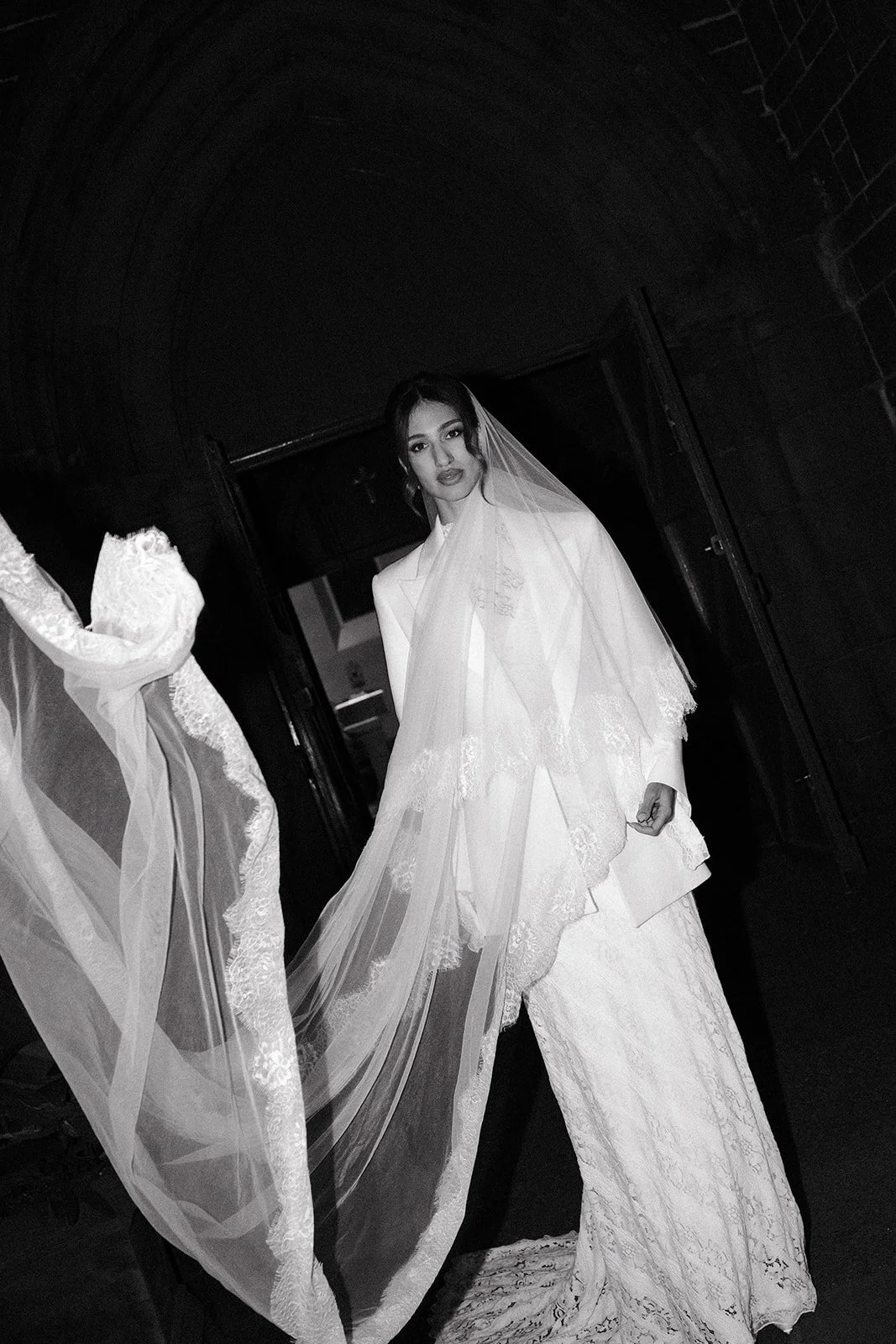 A bride with a long, flowing veil at her wedding at a church in Fitzroy.