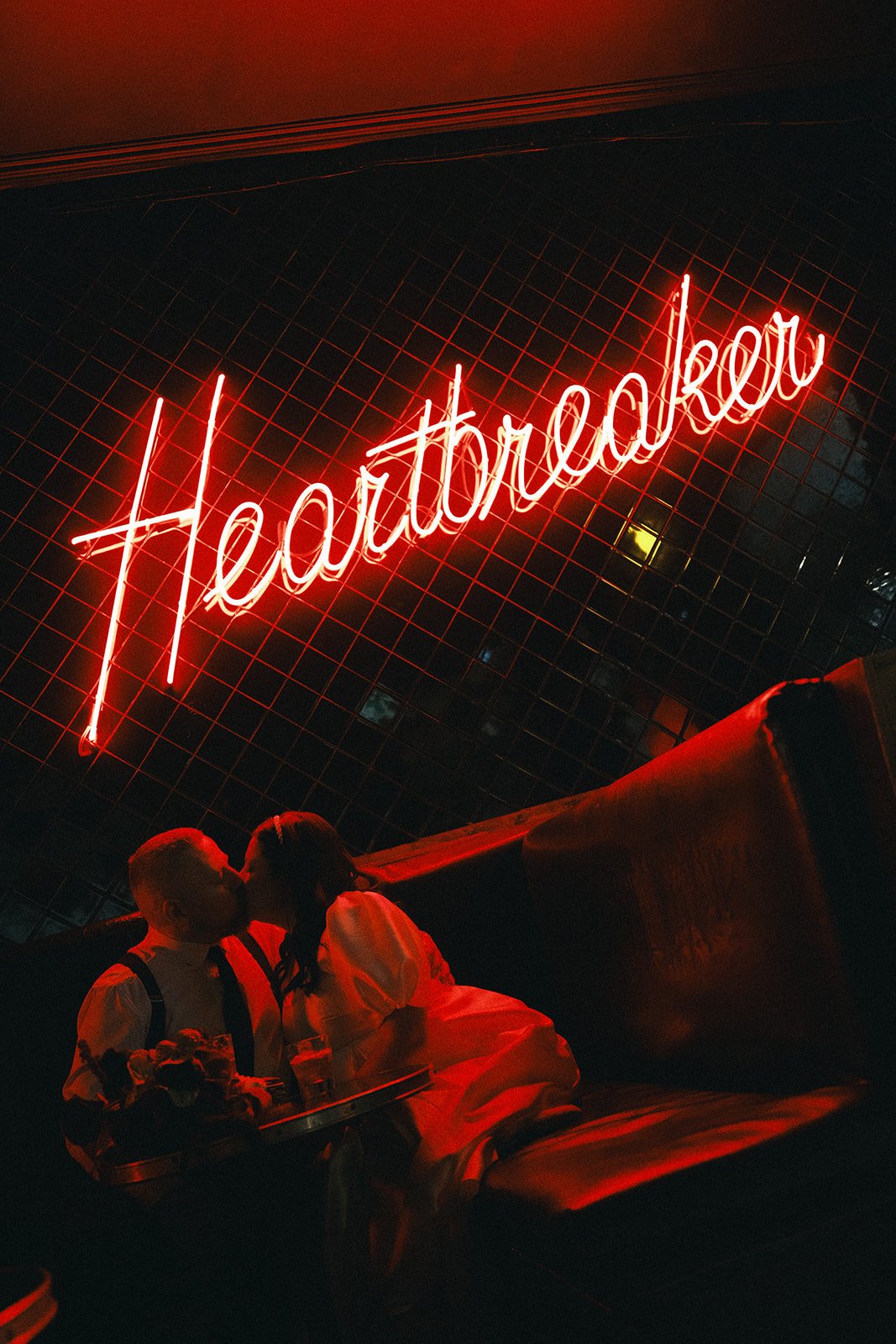 A bride and groom sharing a kiss after their wedding at Heartbreaker Bar in Melbourne.