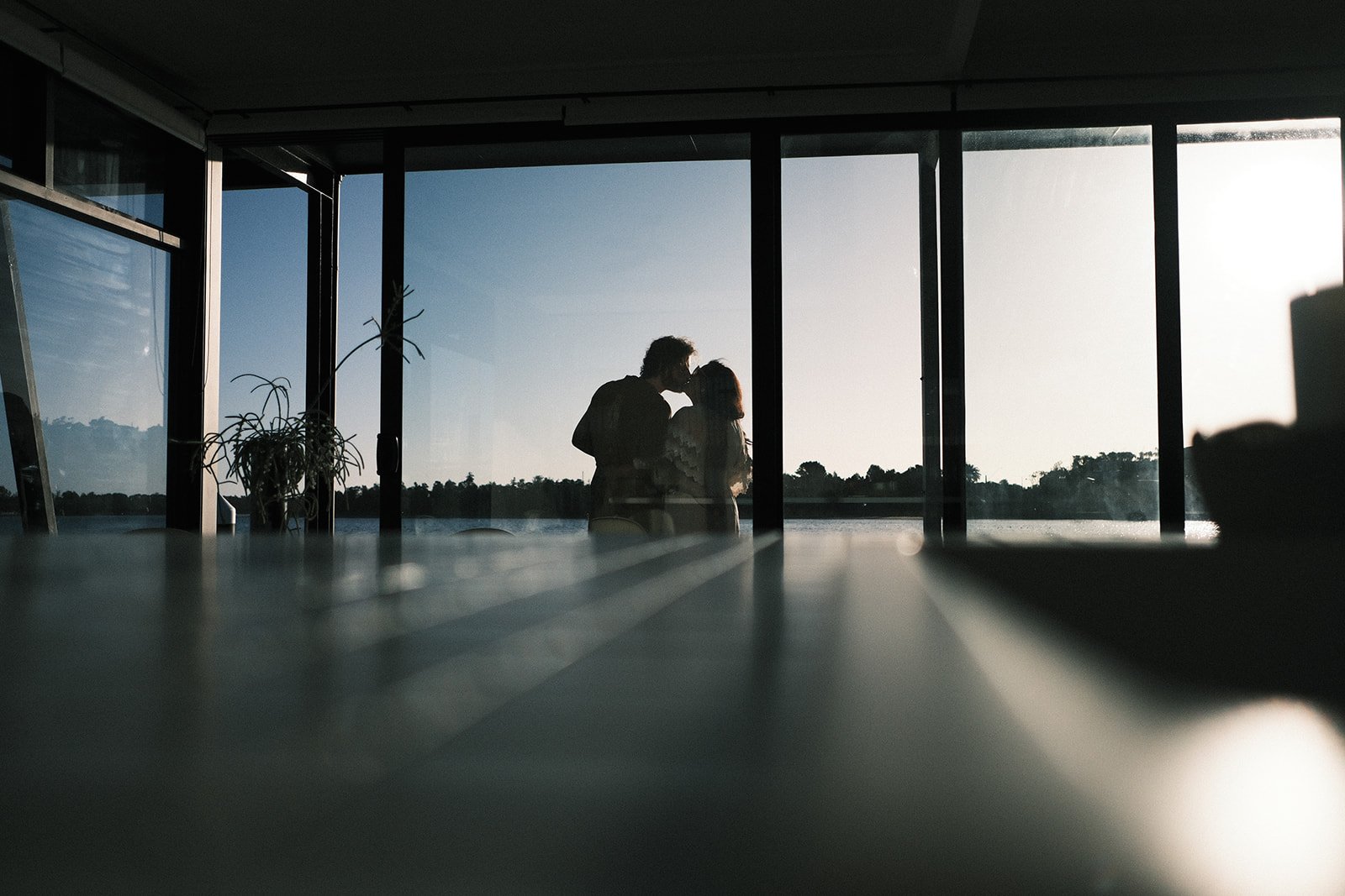 A couple holding hands over a dinner table at their engagement shoot in Melbourne.