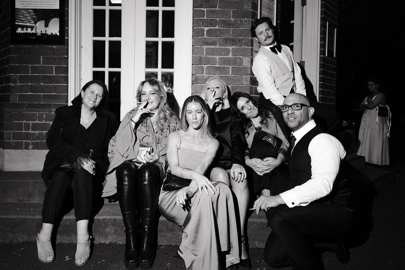 Wedding guests posing with cigarettes at a wedding in Collingwood.
