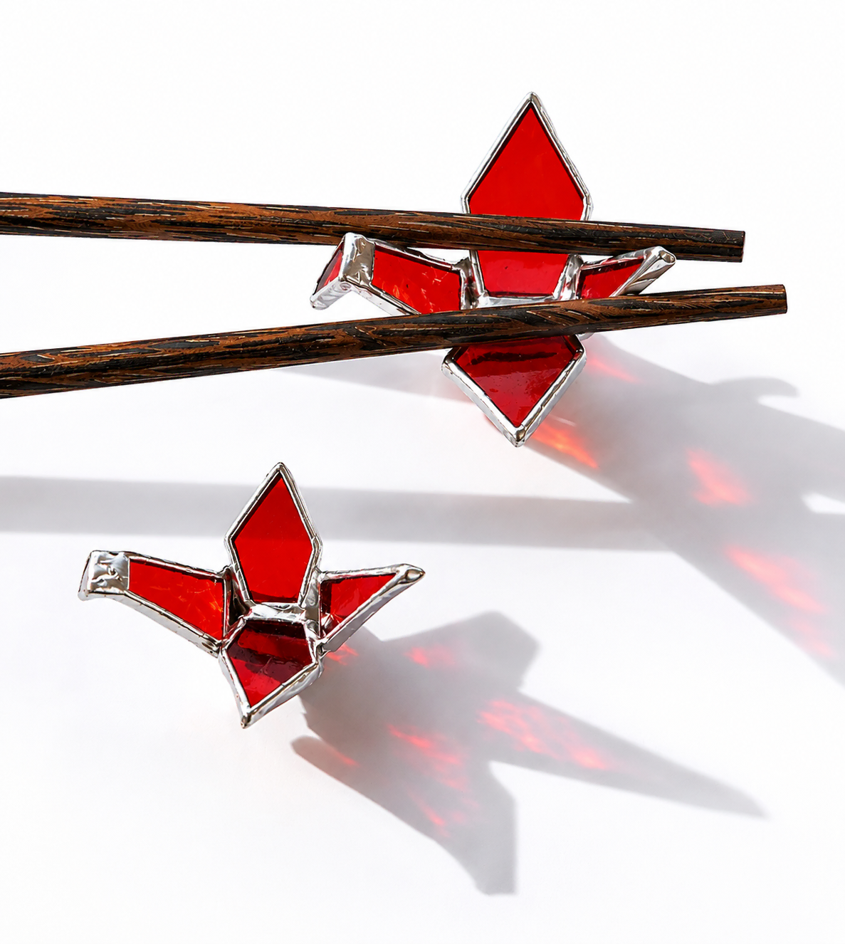 Origami Cranes stained glass artwork by Marie ART Gallery, featuring two handcrafted red glass cranes with silver solder lines.