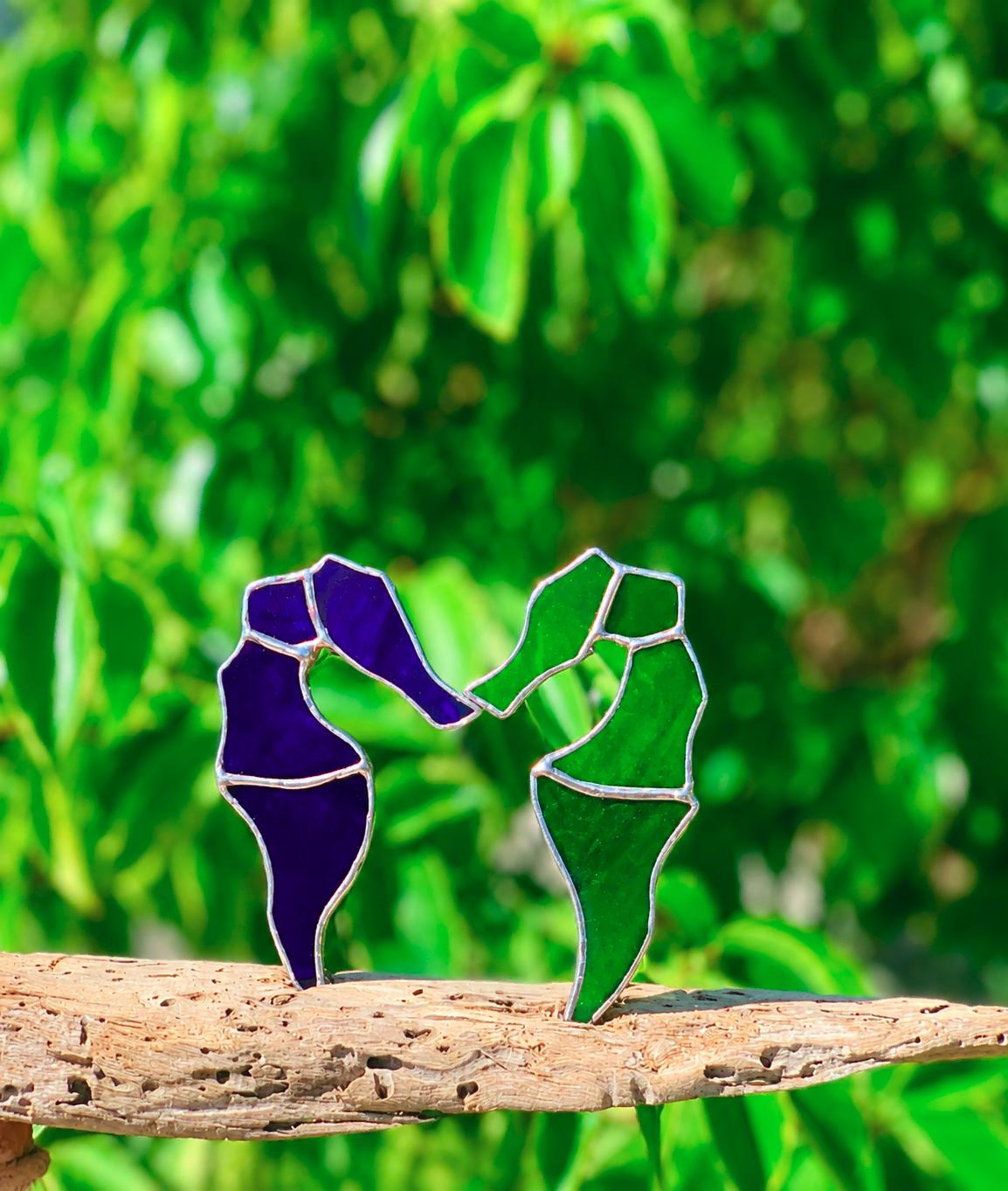 stained-glass-dancers-on-driftwood.webp