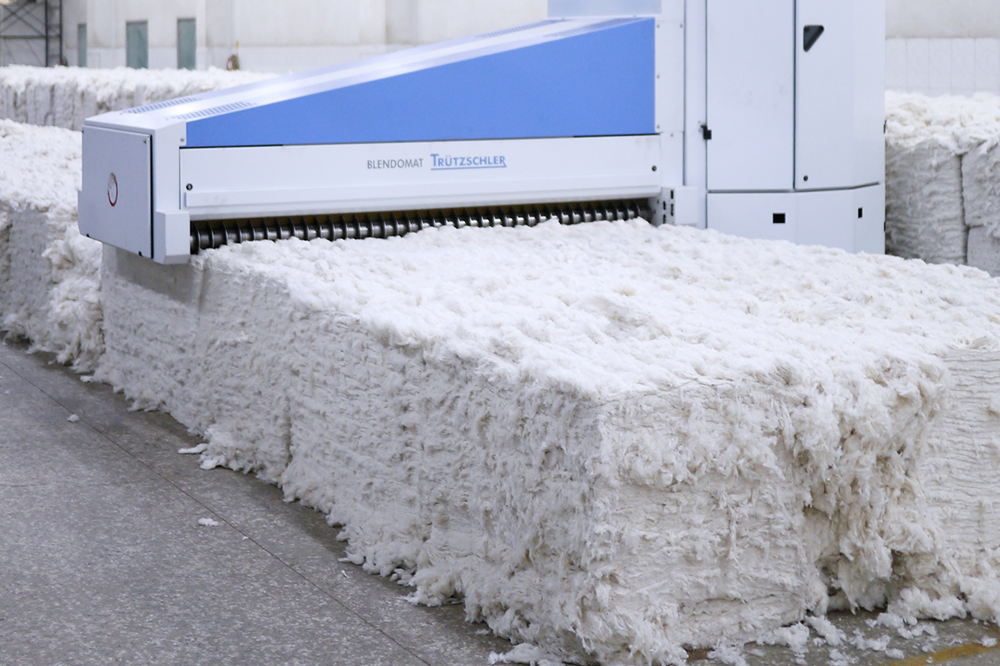 Industrial cotton processing machine producing raw cotton bales