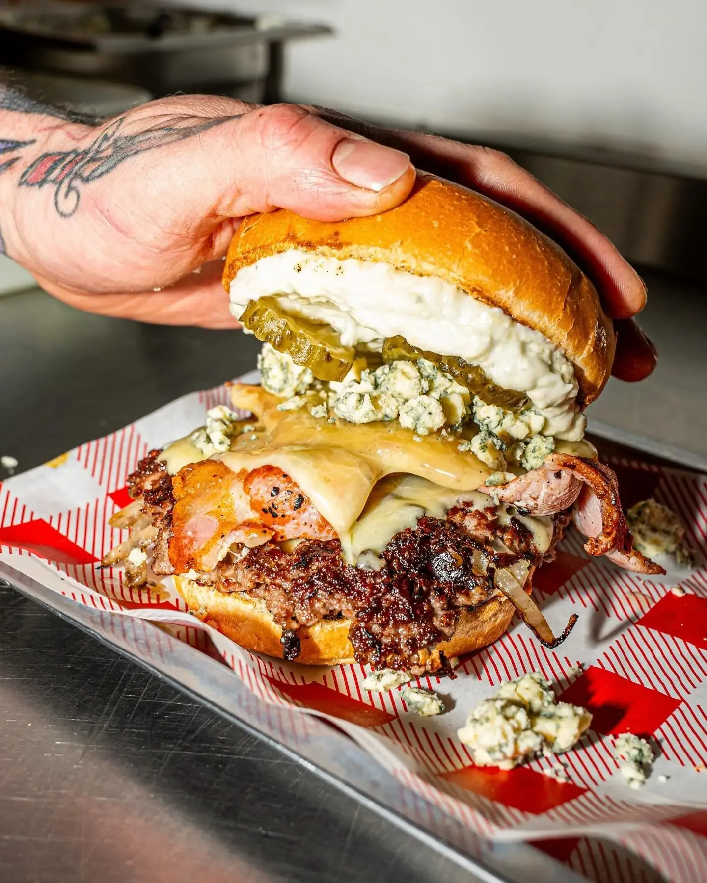 Blue My Mind smash burger with Brighton Blue cheese, bacon and pickles at Boysterous Burgers