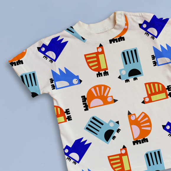 Bold and Colourful geometric bird design all over print on a t-shirt, also great for childrenswear and lifestyle products