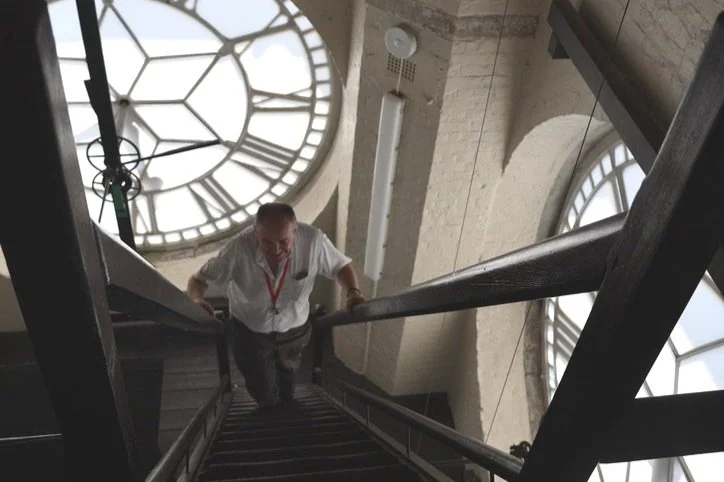 Islington Walk's tour guide climbing the Caledonian Road clock tower.