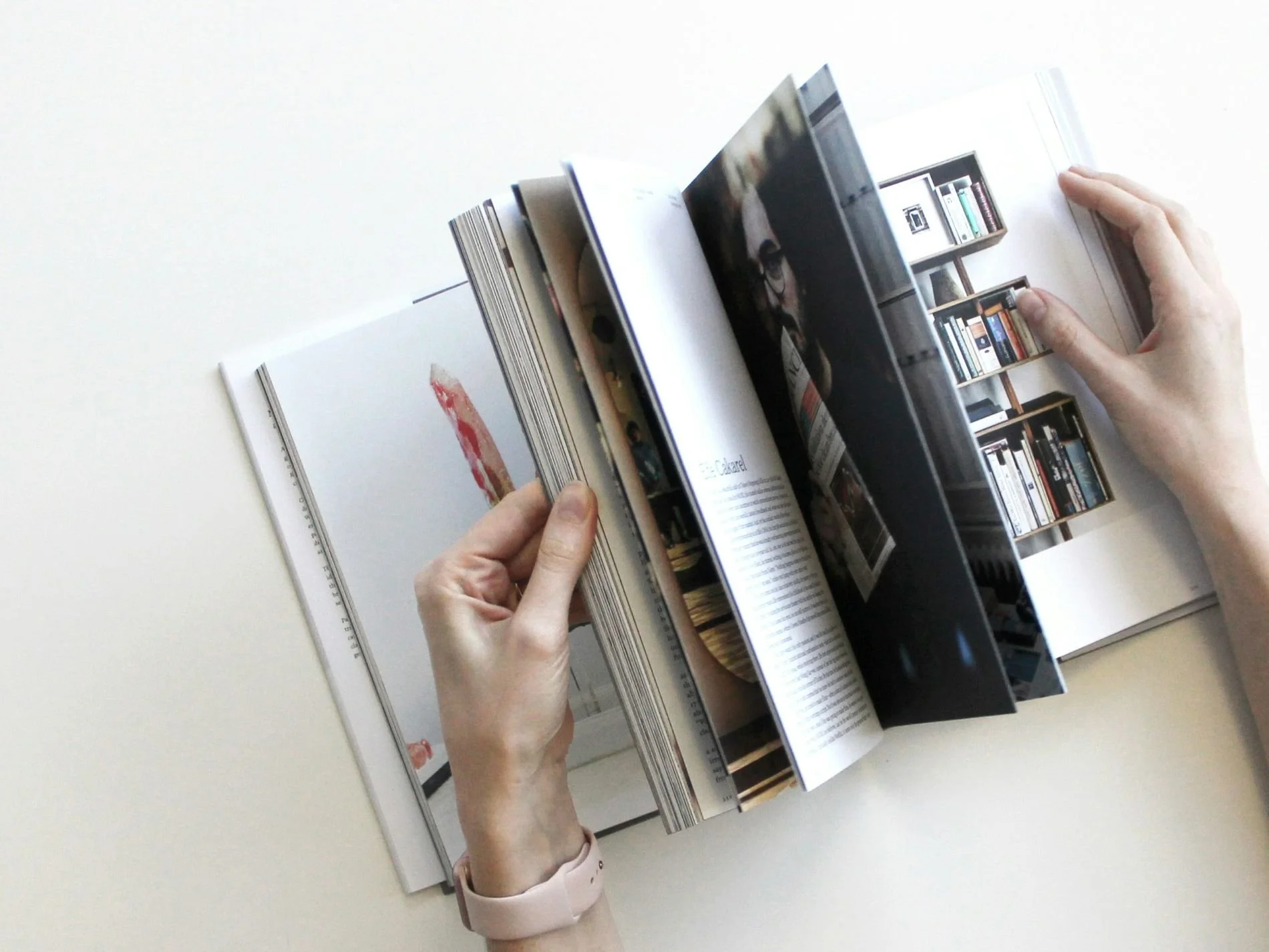 Photo of hands flicking through a brochure.