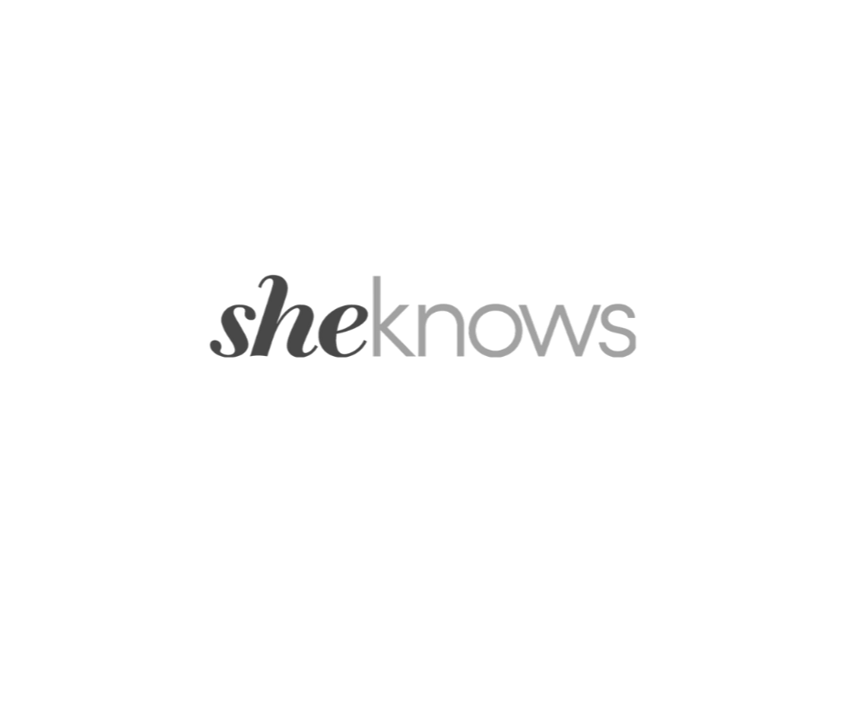 Logo with the text 'sheknows' in stylized font, featuring a black background and gray text.