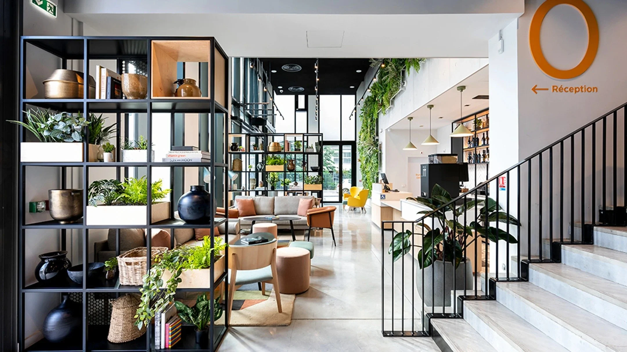 Luxurious modern lounge with a curved bar, high-back chairs, and an elevated seating area illuminated with warm orange lighting, overlooking a city skyline through large glass windows.