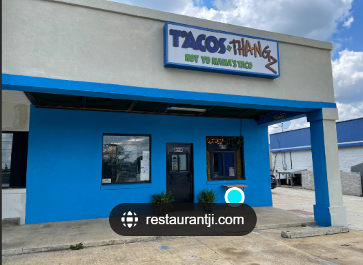 Blue building with a sign that reads "Tacos Thang" and "Not Yo Mama's Tacos," with the website restaurantji.com displayed in front.