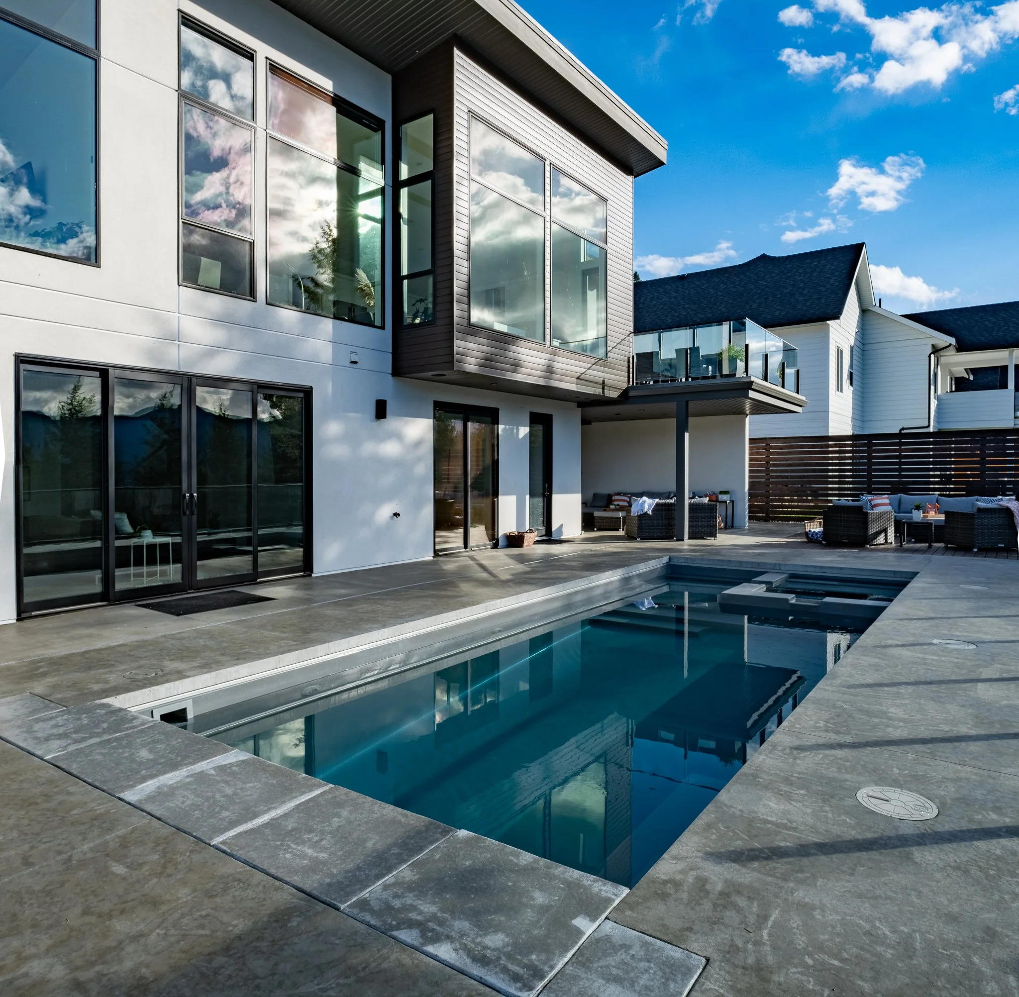 Modern house exterior with a swimming pool and patio area
