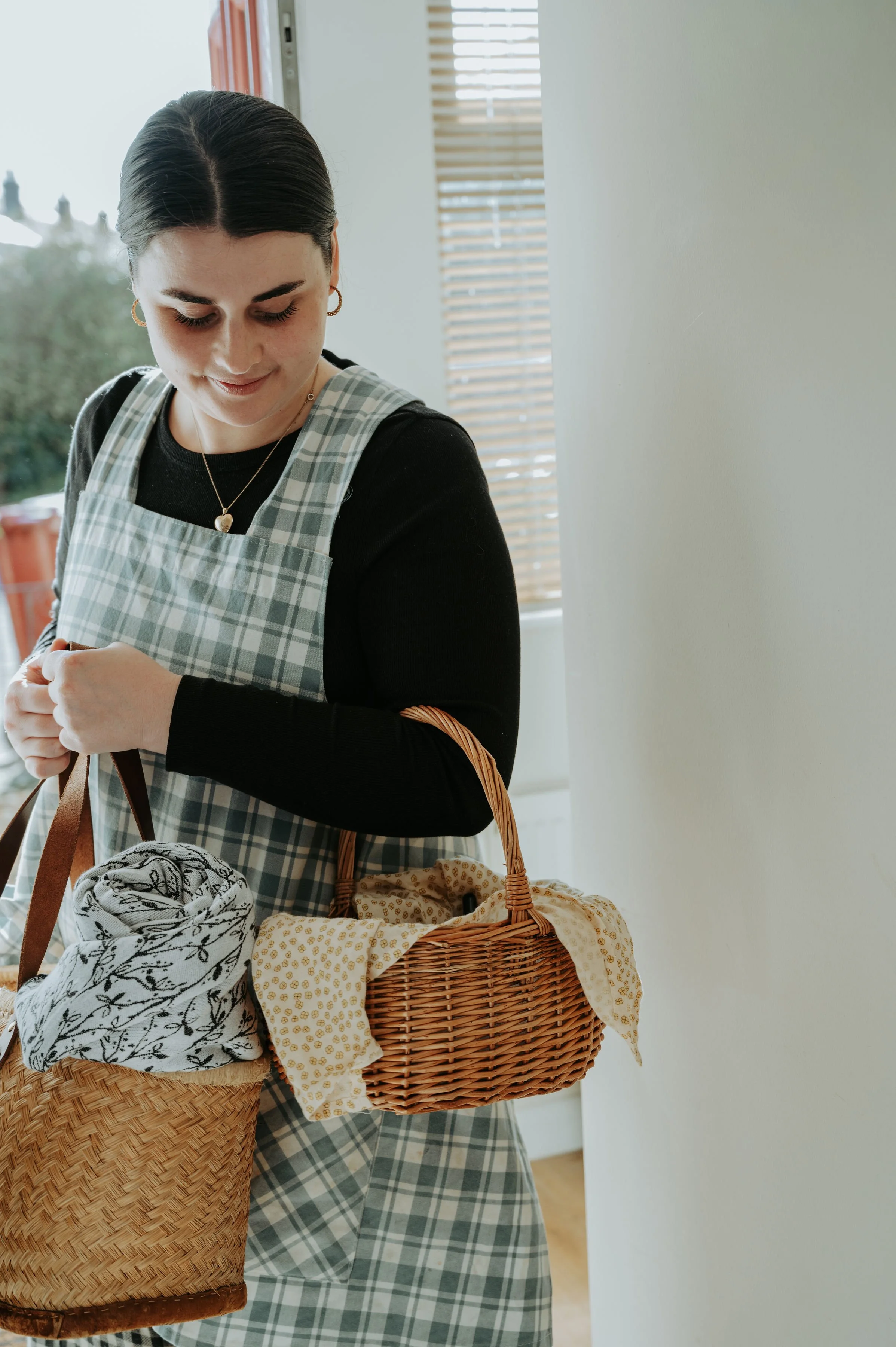 Simple brown line drawing of a crescent moon with a spiral inside, surrounded by small stars and dots.