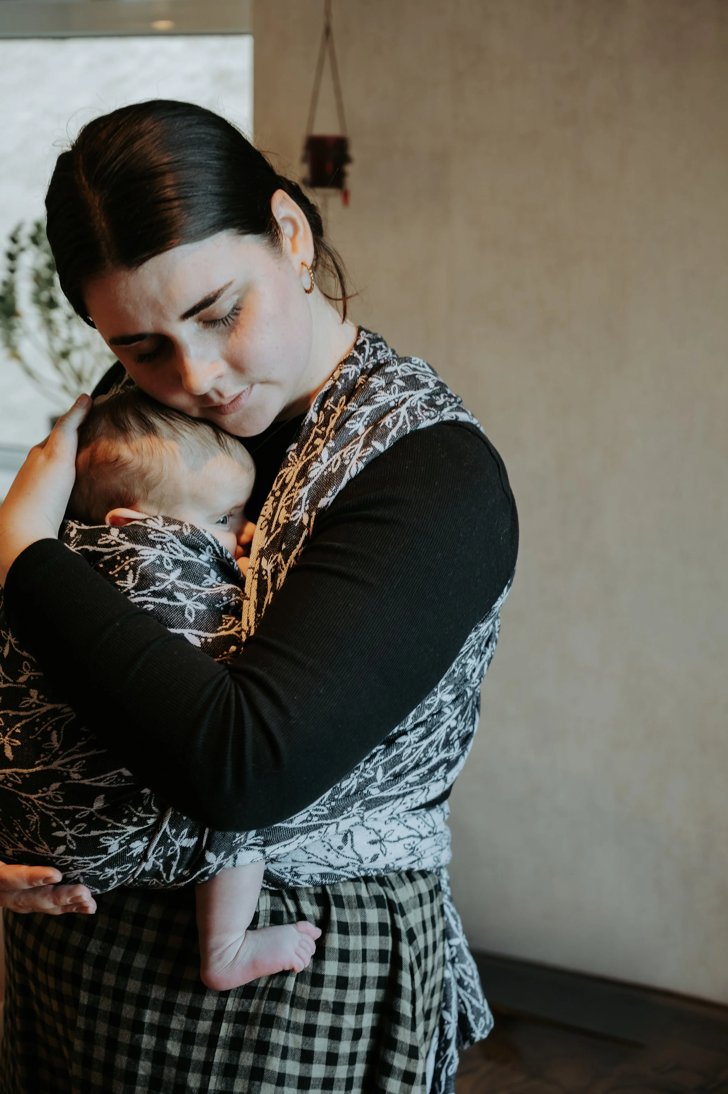 Drawing of a crescent moon with a spiral design inside, rooted with tree roots at the bottom.