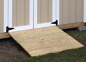 Wooden ramp leading to shed doors