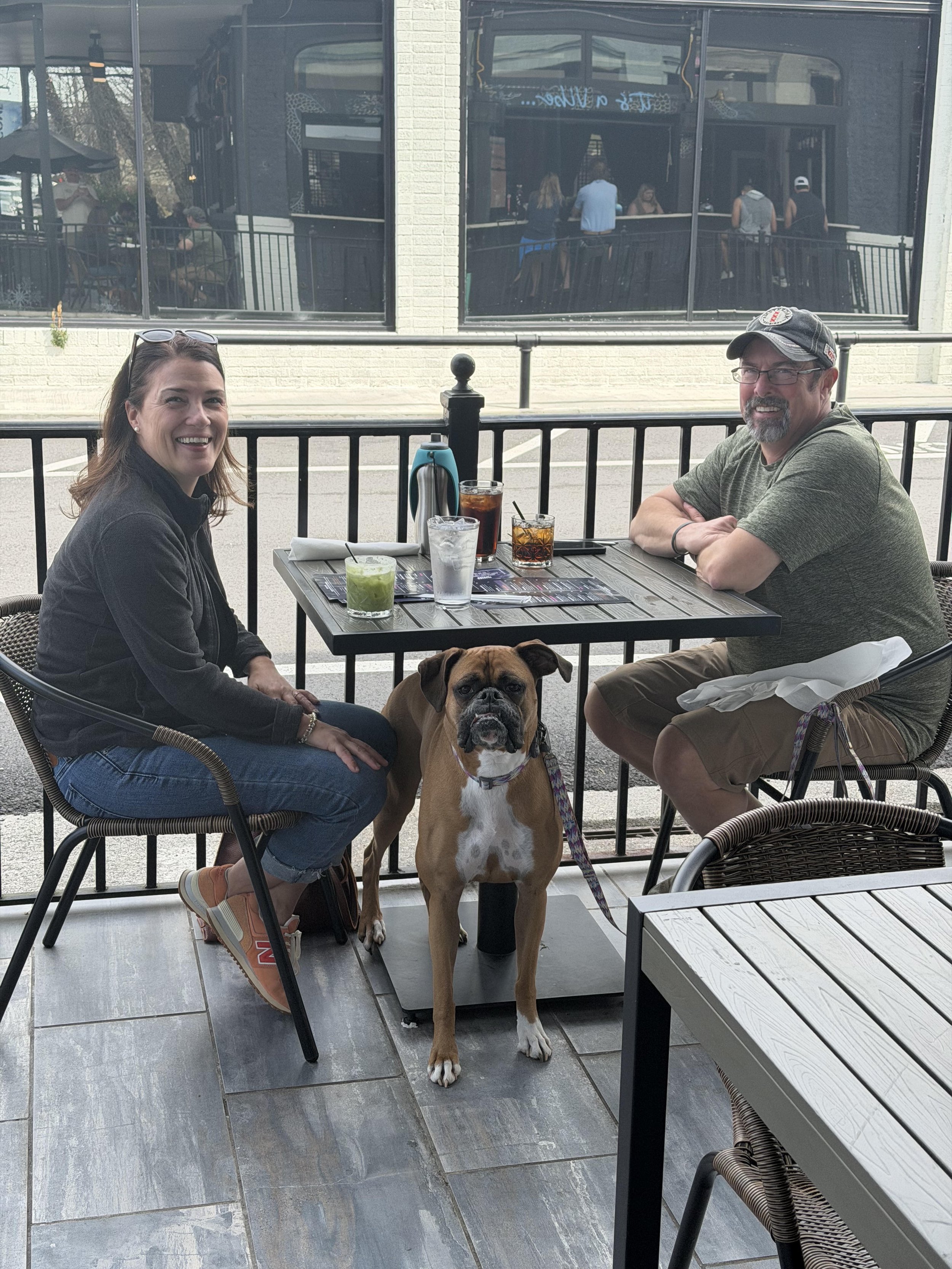 Couple with their boxer dog on the patio at Rabun Social, a dog friendly restaurant in Clayton GA