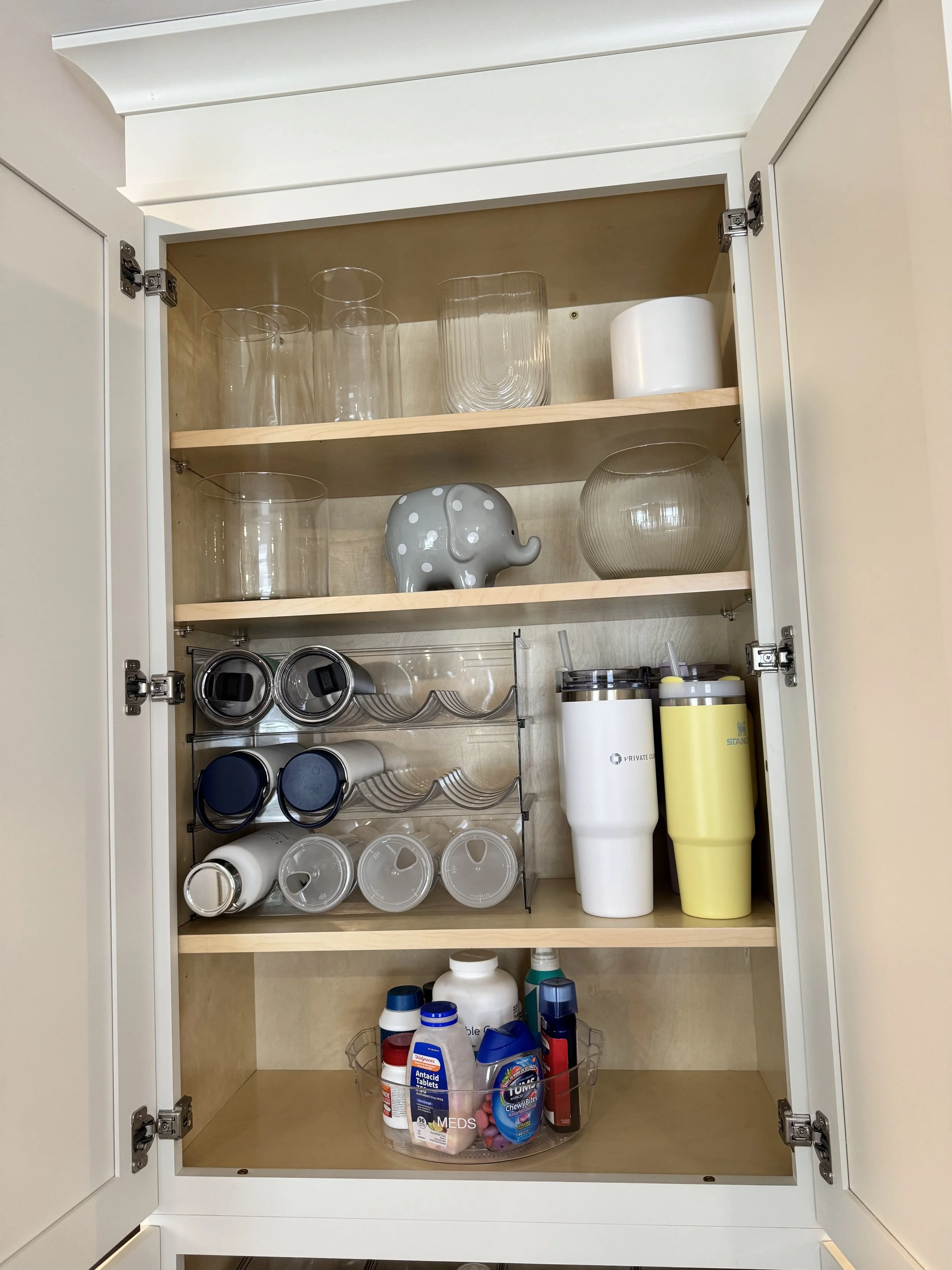Water bottles organized in a kitchen cabinet