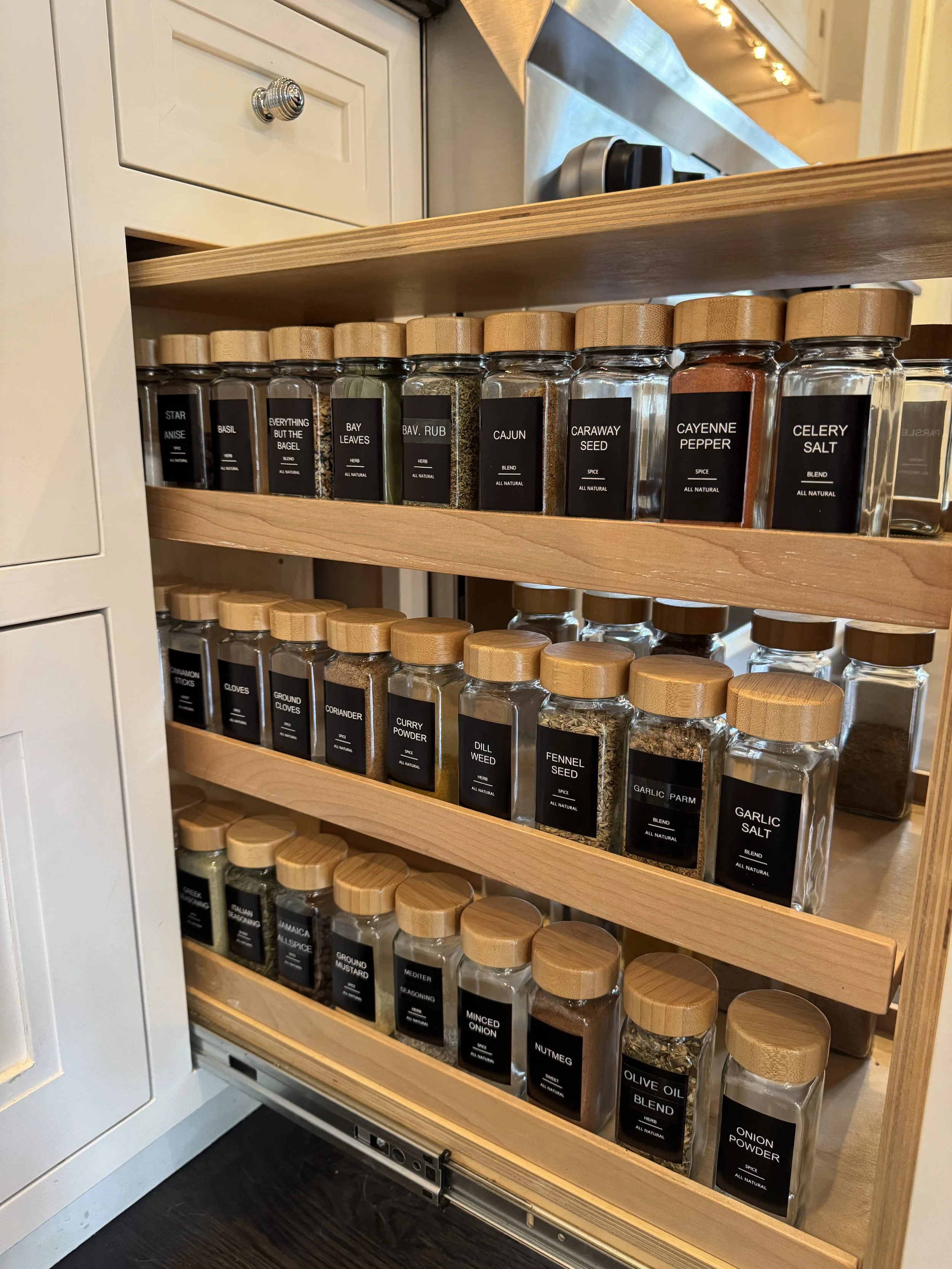 Matching glass spice jars with bamboo lids and black labels
