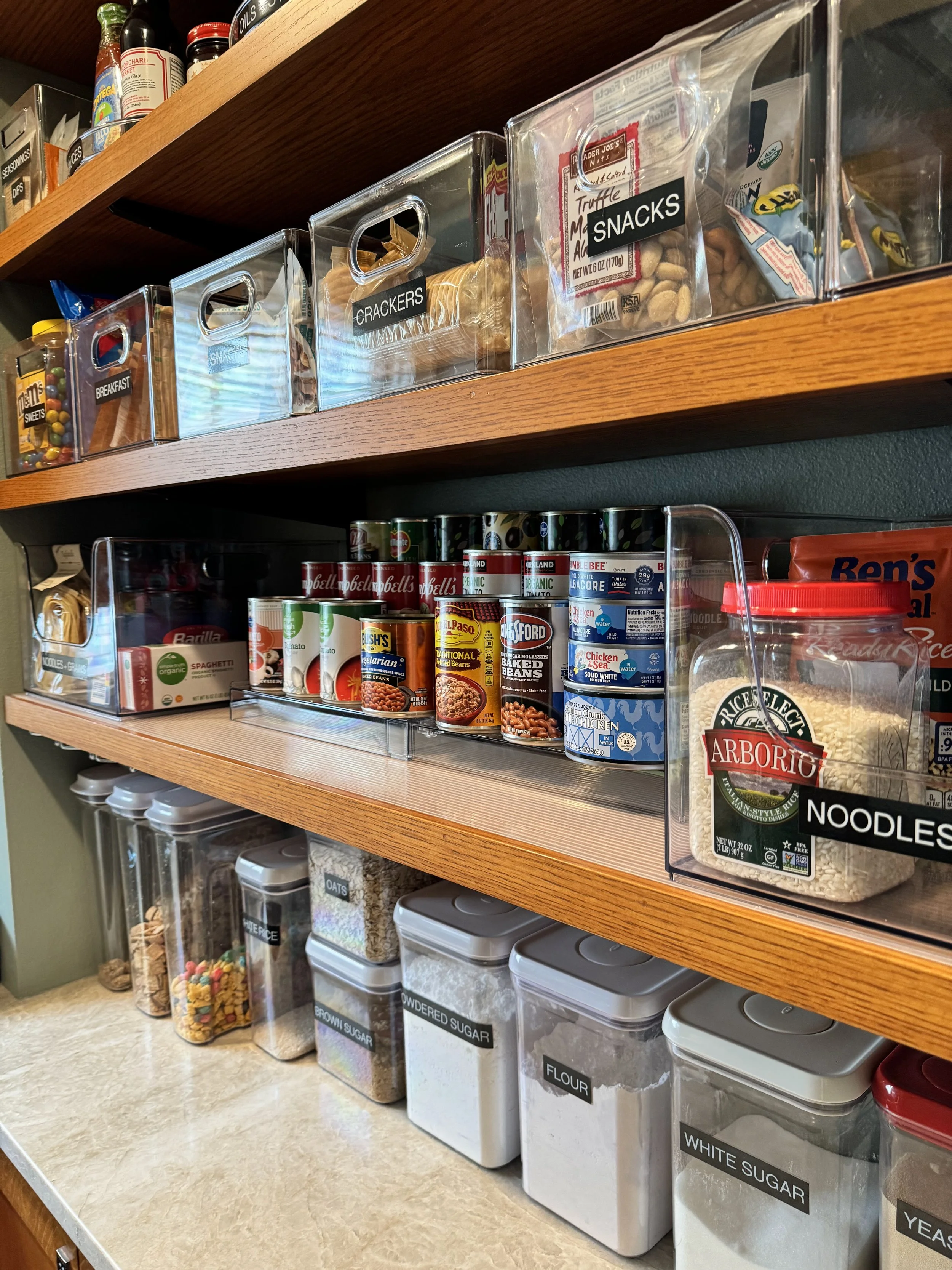 Organized pantry shelves with clear containers and labels