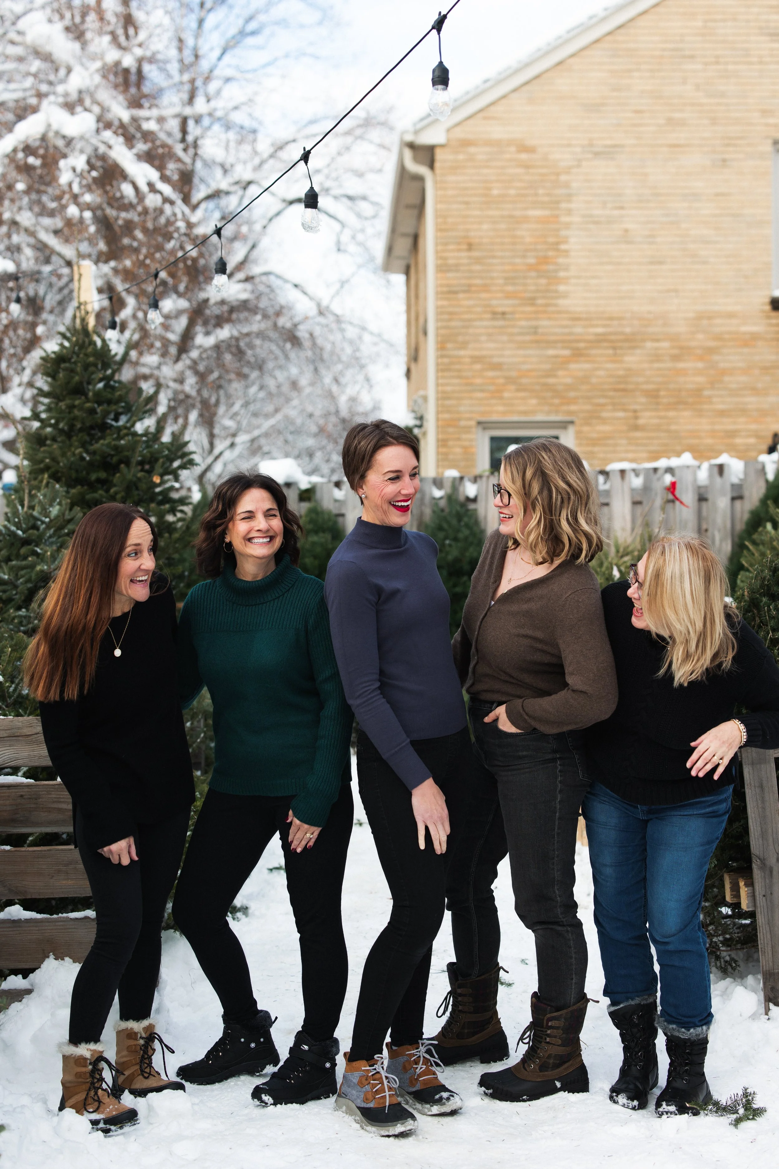 Group of professional organizers wearing black standing outside in the snow