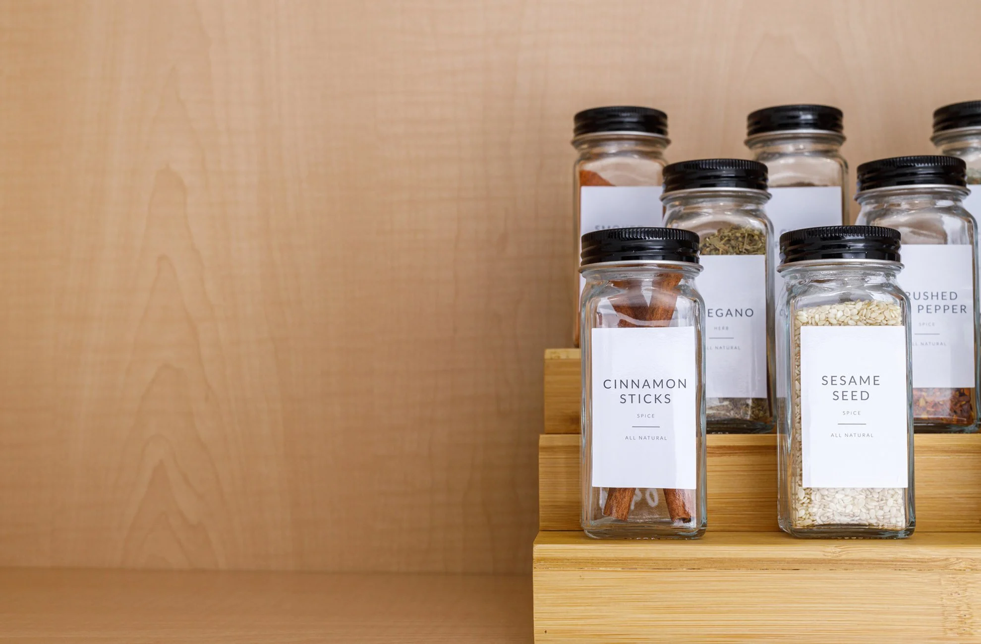 spice jars with black tops and white labels