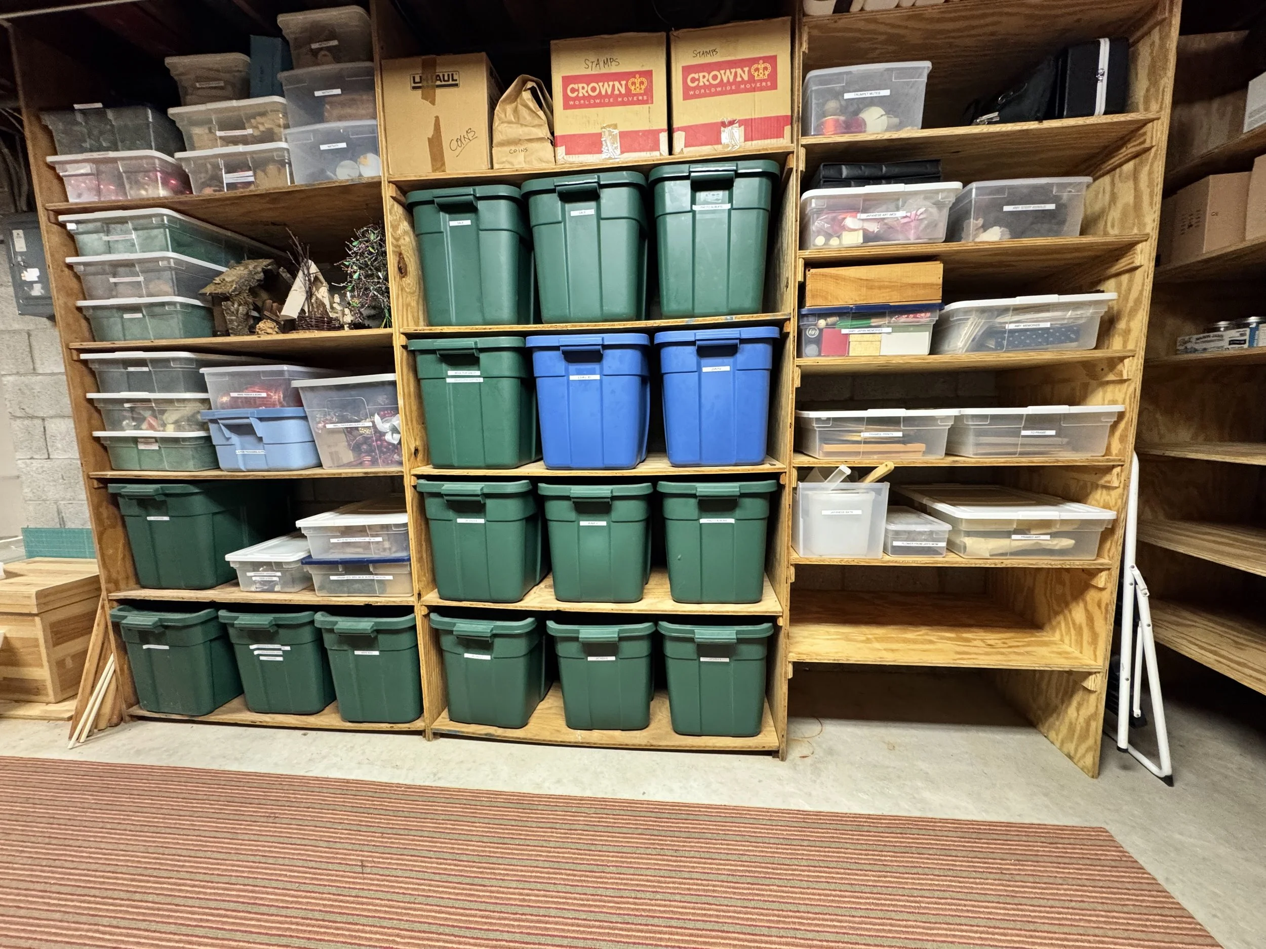 an organized basement with green and blue bins and white labels