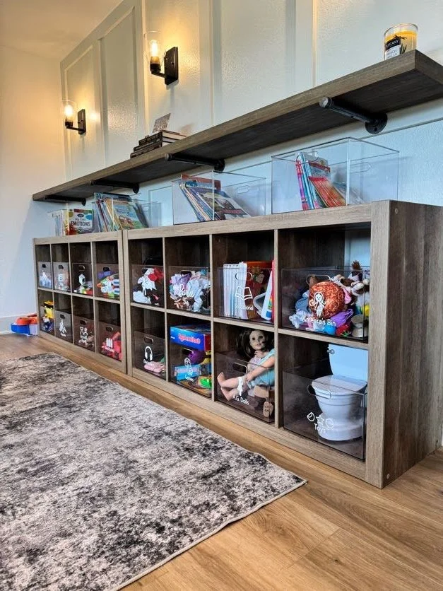 A wooden cube storage shelf with clear containers and white labels