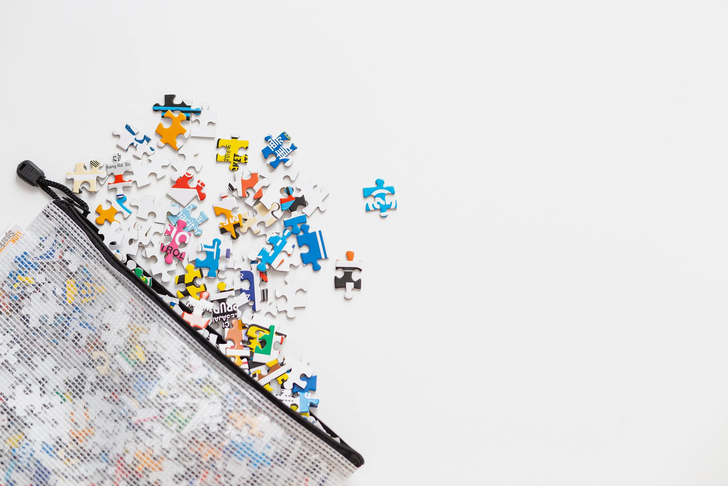 puzzle pieces in a zipper bag with a white background