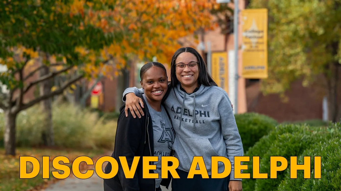Discover Adelphi Email Header: October, featuring two students outdoors by fall foliage