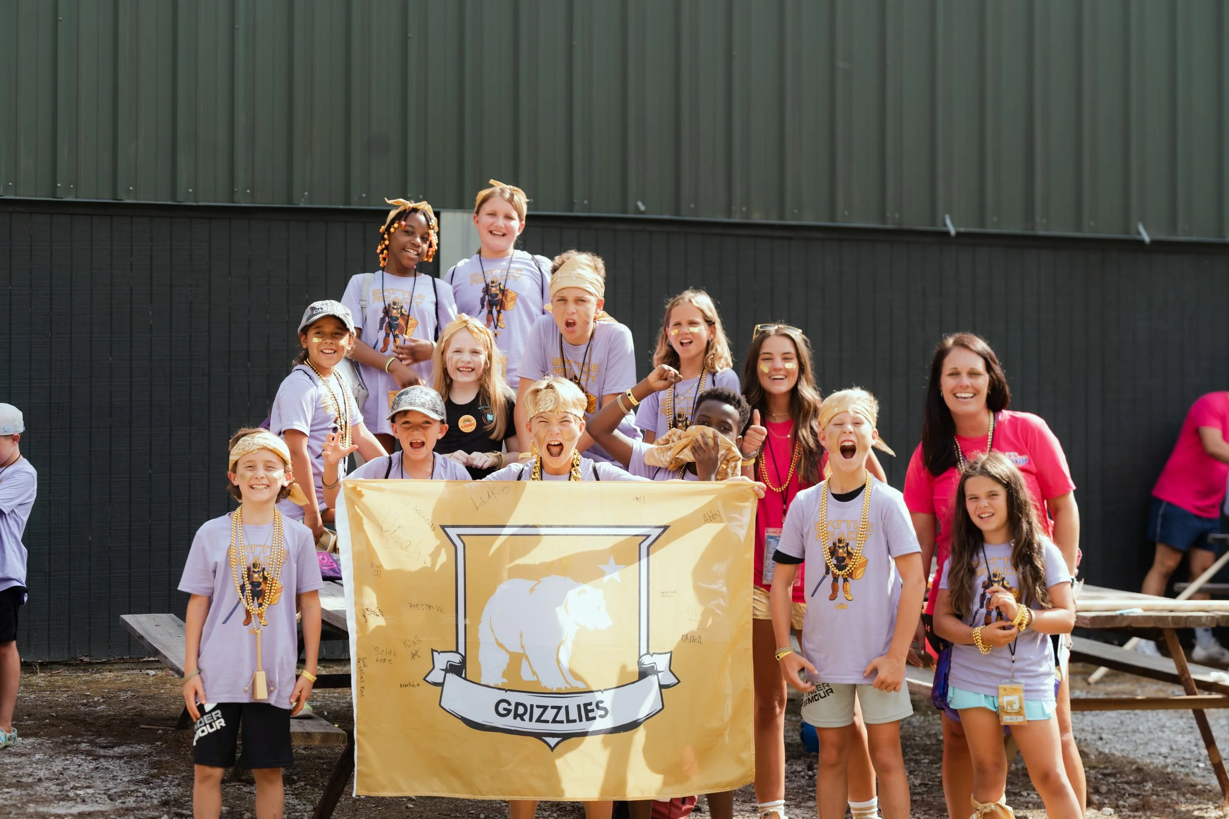 Group photo of one of the teams with their flag