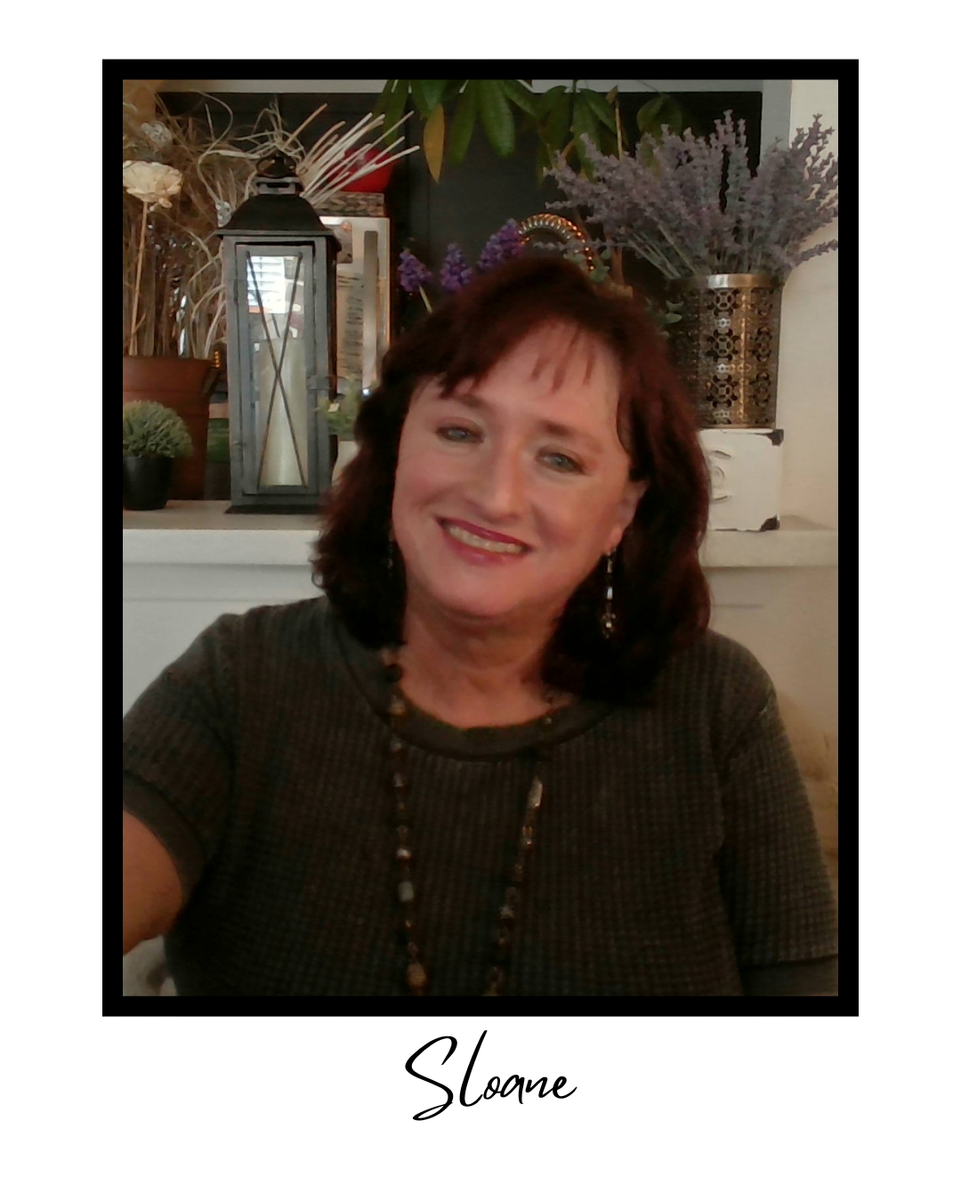 A woman named Sloane smiling on a decorated background with flowers, lanterns, and plants.